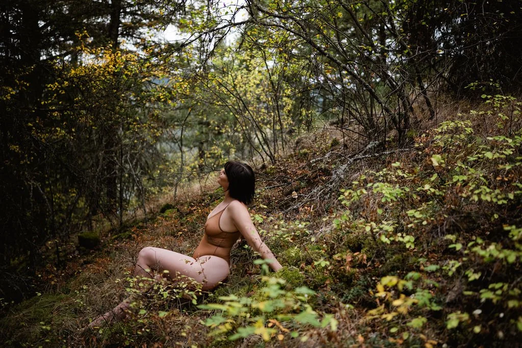 woman basking in the sun in the foliage near sun peaks bc in a nude coloured lingerie bodysuit