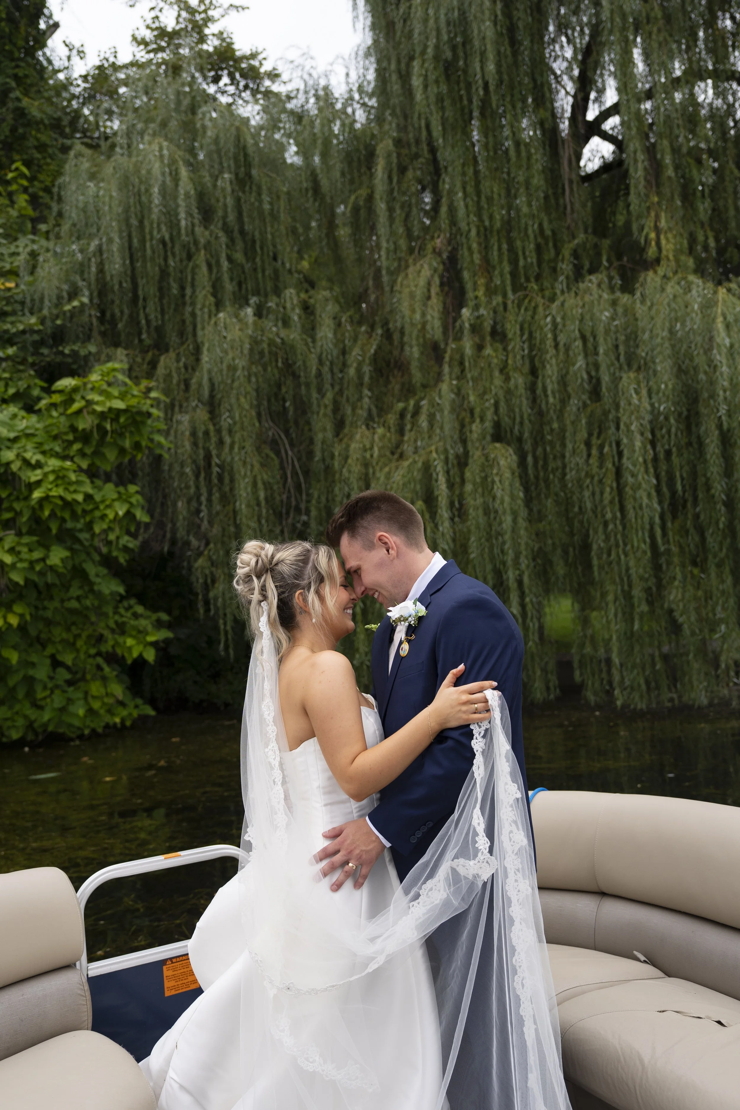 Wedding couple on a boat in Portage Lakes