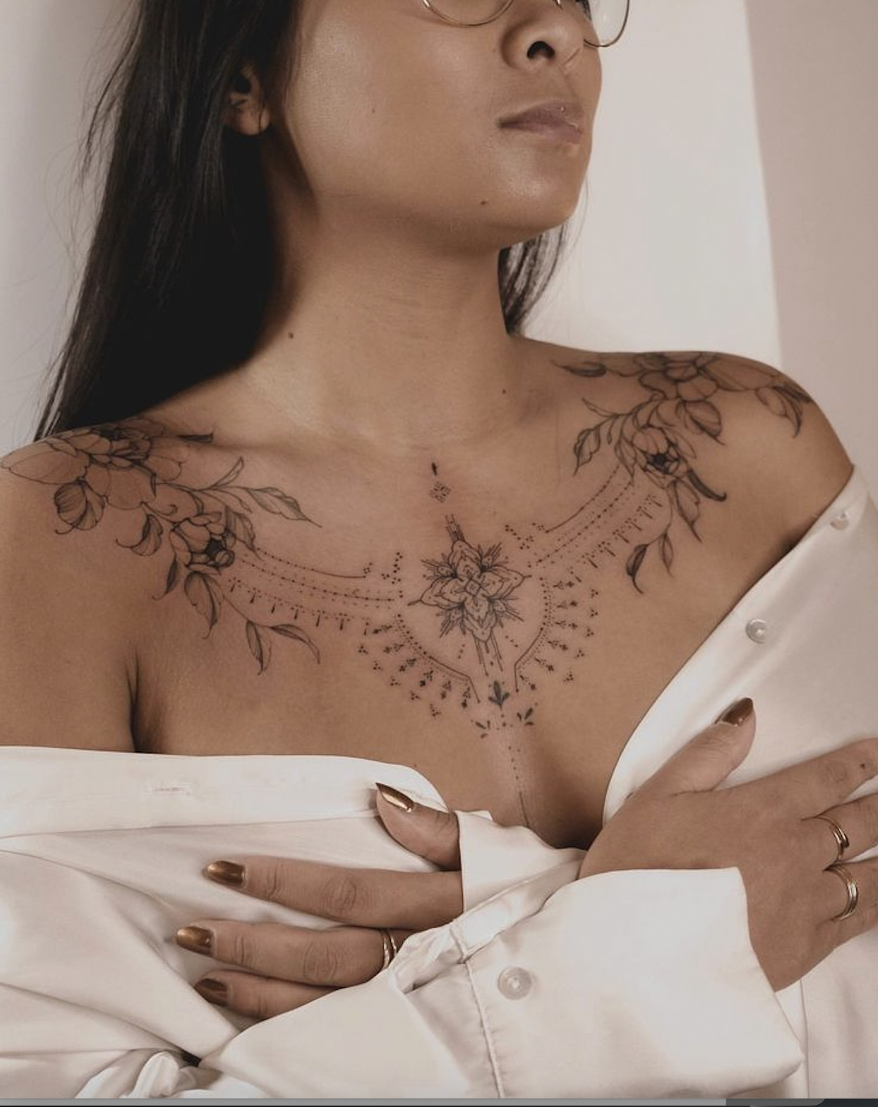 Ladies chest tattoo in fine line floral style following the collarbones with soft symmetry, Toronto Oakville Zen Tattoo Studio