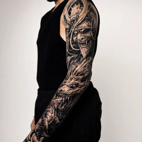 Large-scale black-and-grey realism sleeve dragon tattoo