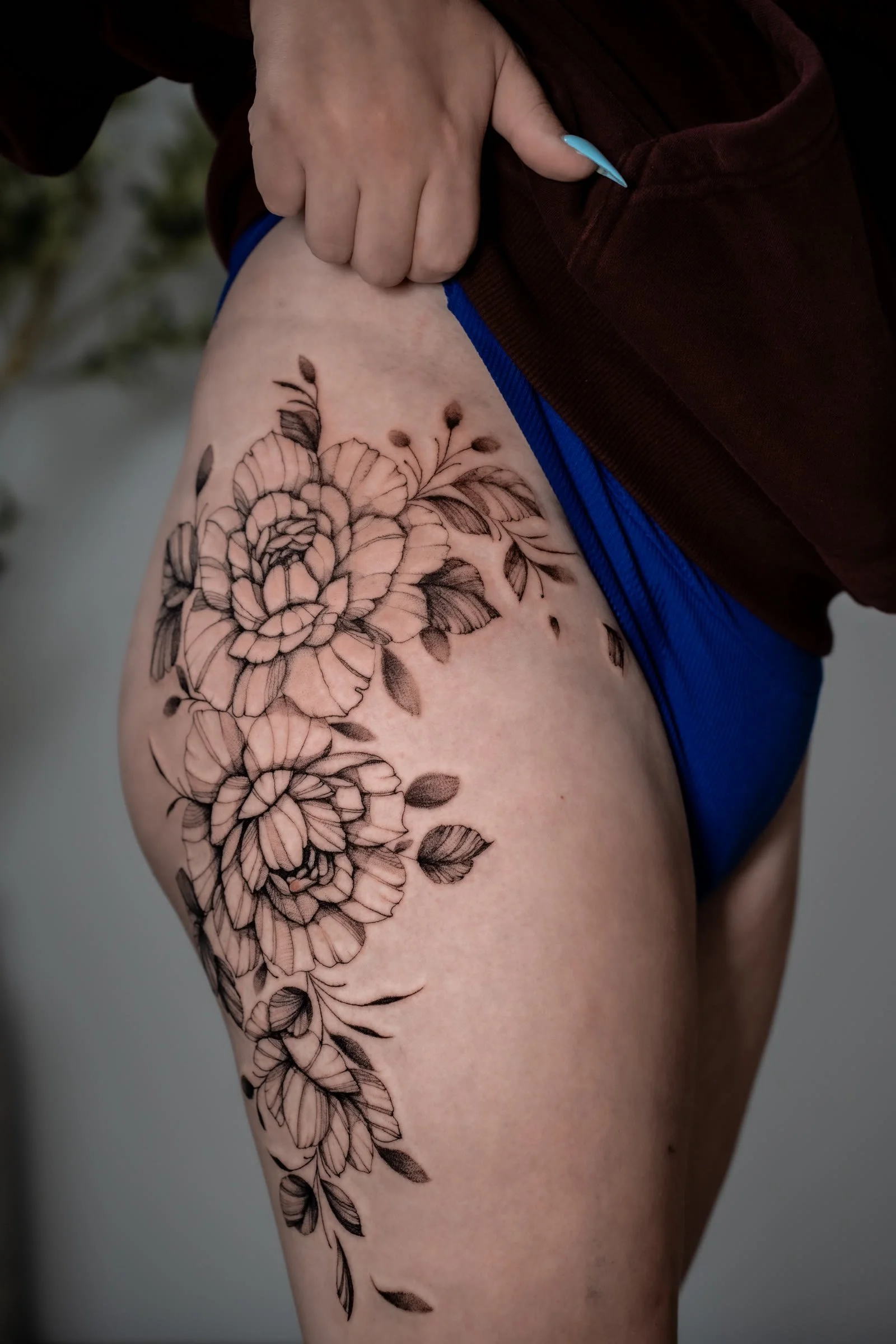 Fine line black and grey floral peony thigh tattoo by Oxy at Zen Tattoo Studio Oakville