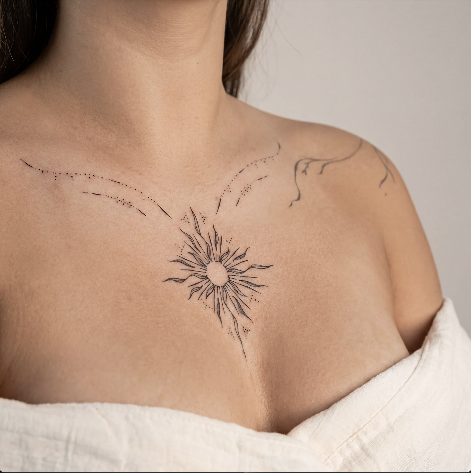 Micro realism flower female chest tattoo in black and grey with soft shading and feminine placement, Zen Tattoo Studio Toronto Oakville