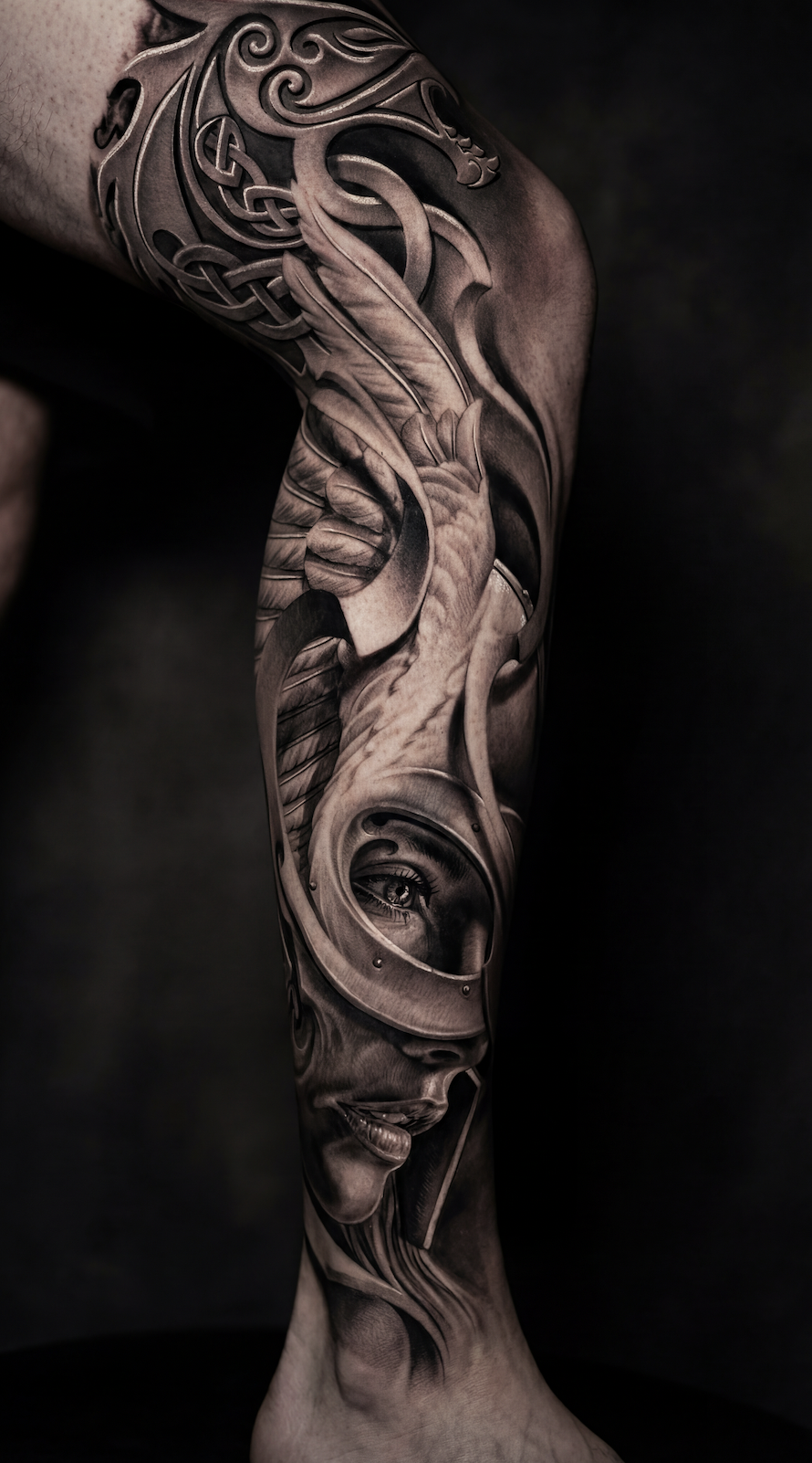 Leg tattoo ideas for guys featuring a black and grey realism leg sleeve with flowing smoke and filigree connector design wrapping the calf with ornamental patterns and a realistic eye portrait