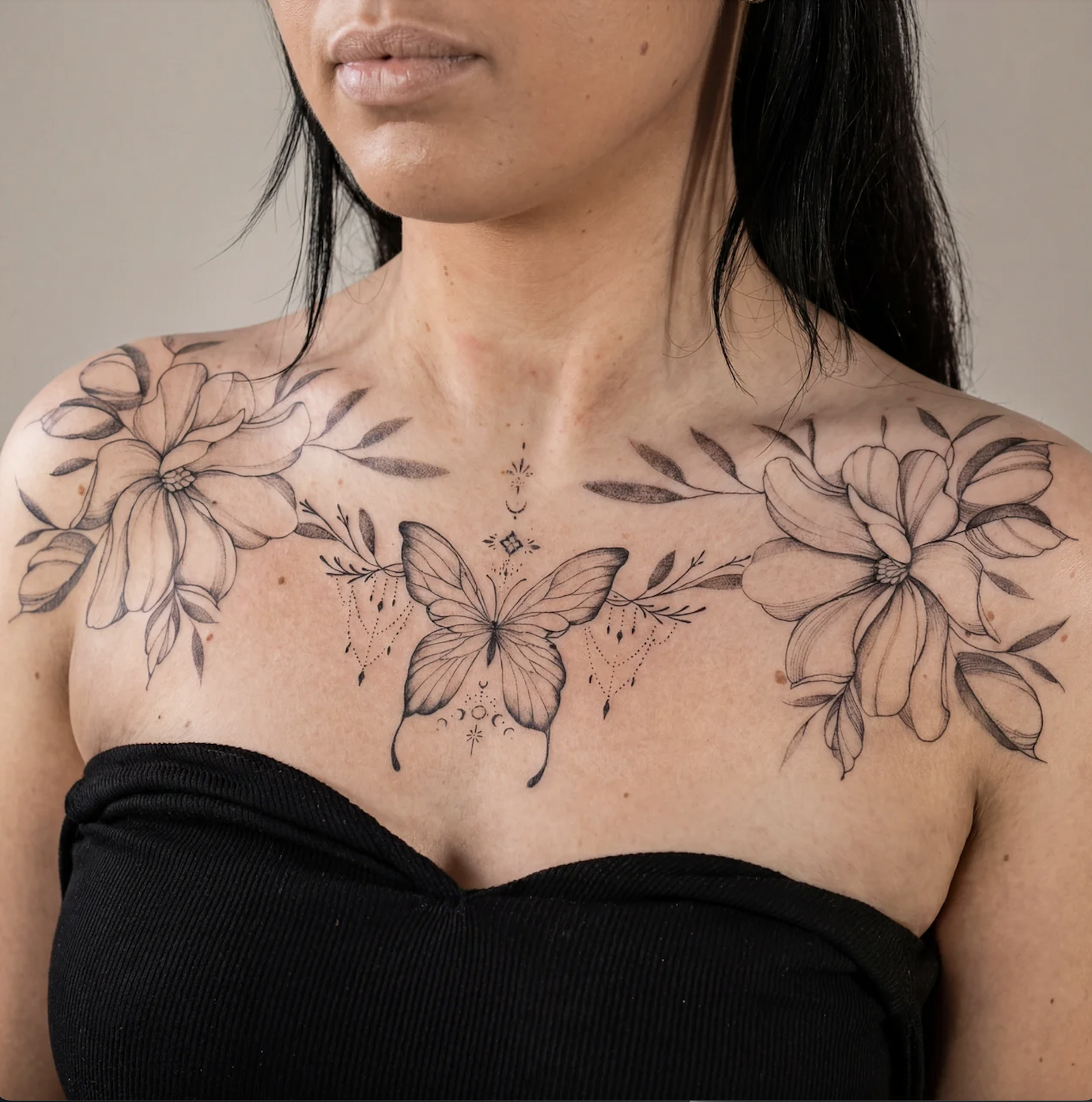 Small fine line flower chest tattoo on collarbone for women, delicate feminine placement, Zen Tattoo Studio Toronto Oakville