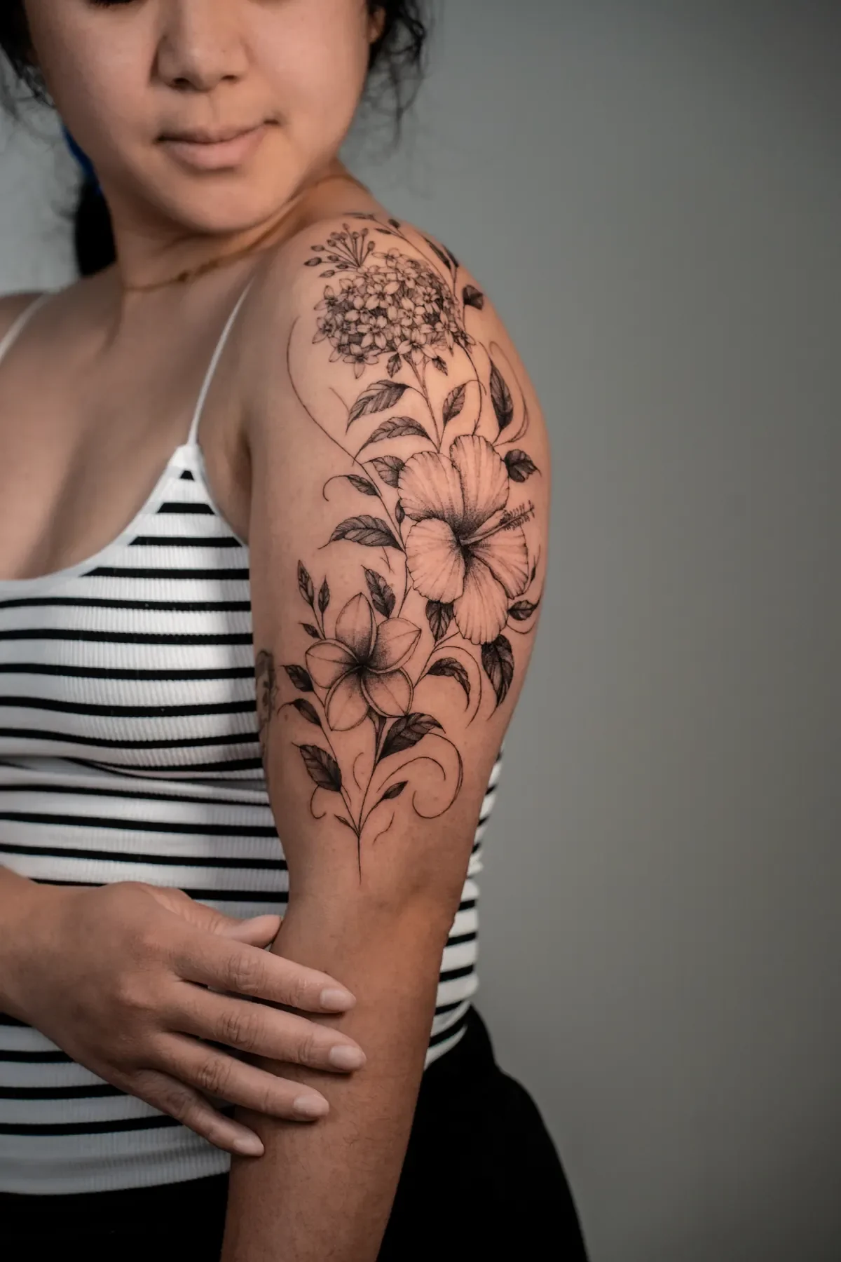 Large-scale fine line floral tattoo on the shoulder and upper arm, black and grey, Zen Tattoo Studio Oakville.