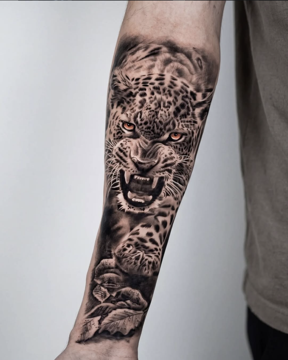 Photorealistic leopard tattoo in black and grey by Luis Fernandez, Zen Tattoo Studio Oakville. Animal realism forearm piece — spot texture, snarl detail, and depth across a full forearm canvas