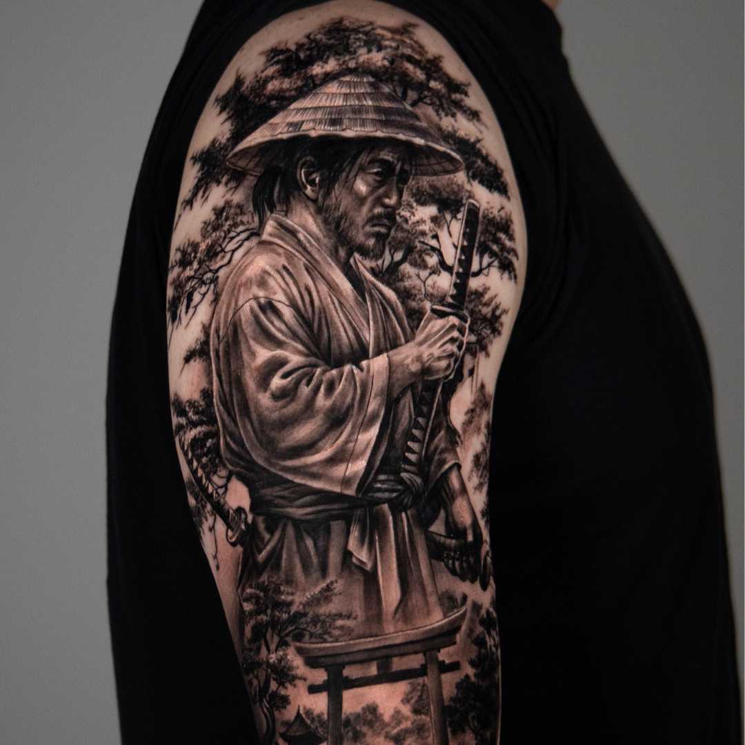 Tattoo of a samurai warrior with a sword, wearing a traditional hat, set against a background of trees and a torii gate.