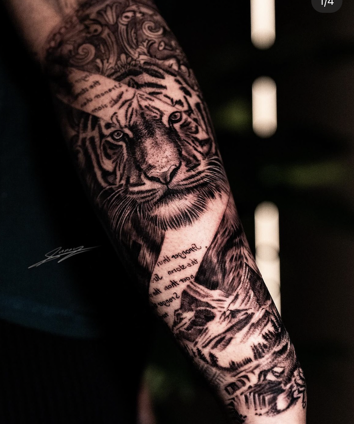 Forearm tattoo of a realistic tiger and artistic details with script.