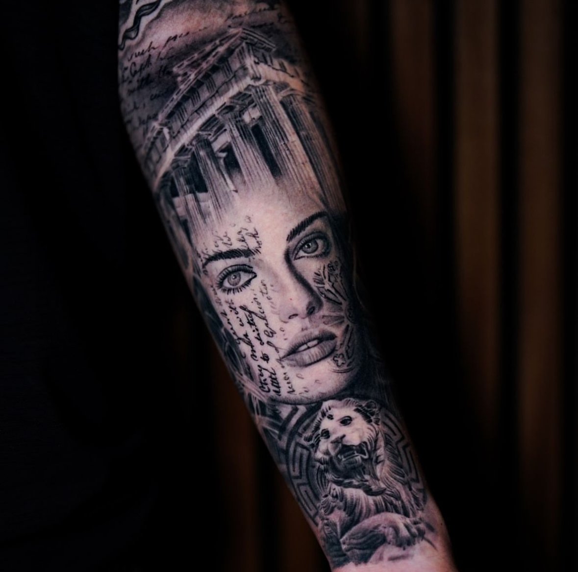 Realistic tattoo on arm depicting a woman's face, Greco-Roman architecture, and a lion.