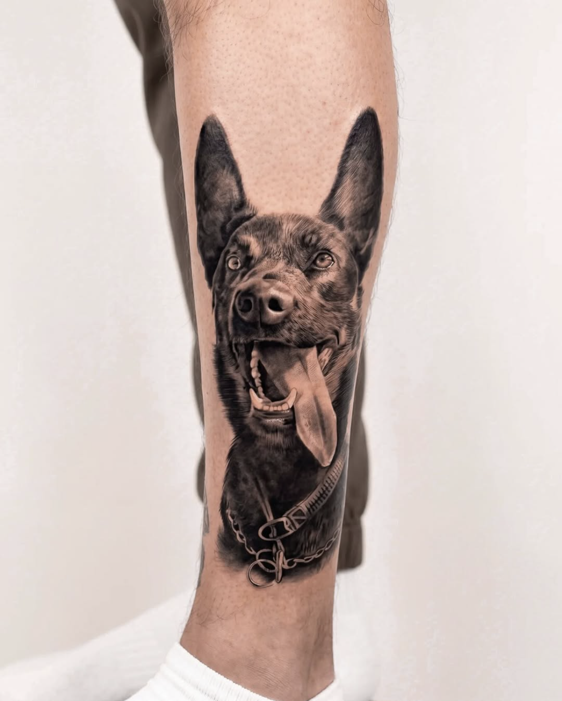 Photorealistic dog portrait tattoo in black and grey by Luis Fernandez, Zen Tattoo Studio Oakville. Custom pet portrait — German Shepherd, forearm placement, true-to-life fur and expression detail.