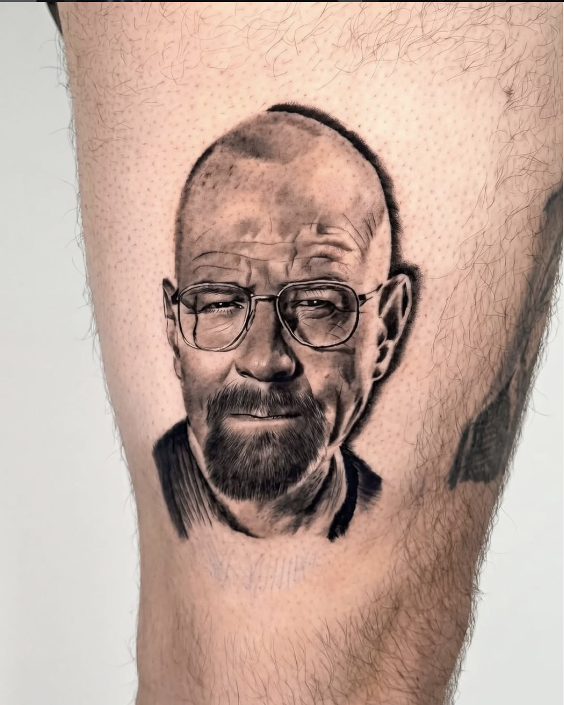 Black and grey celebrity portrait tattoo — Walter White by Luis Fernandez at Zen Tattoo Studio, Oakville. Photorealistic TV character portrait, thigh placement, fine line detail and accurate likeness.