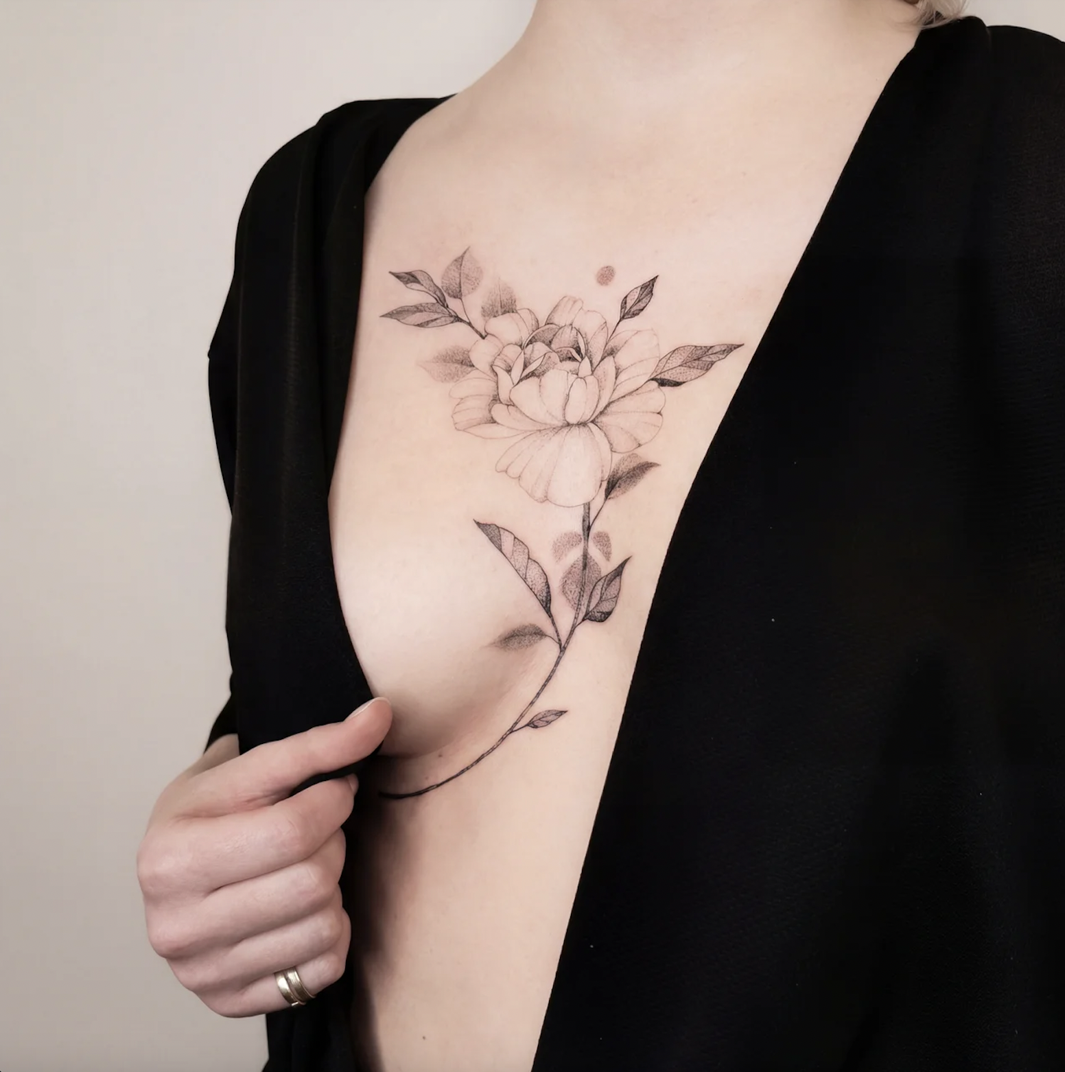 Ladies chest tattoo underboob floral fine line design framing the lower chest, Zen Tattoo Studio Toronto Oakville