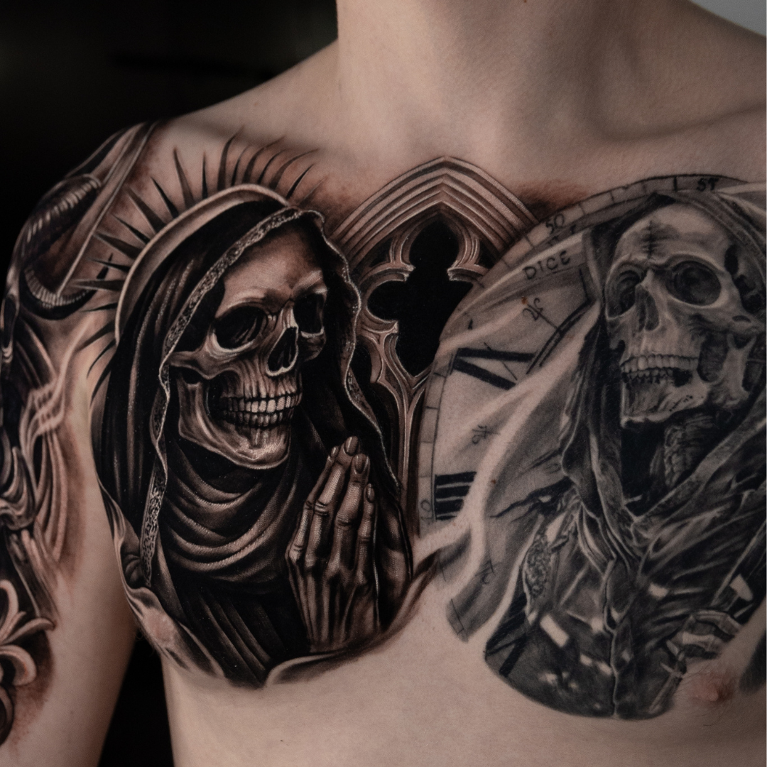 chest tattoo Black and gray tattoo of a praying skeleton with a hood, and another skeleton with a clock face, on a person's chest.