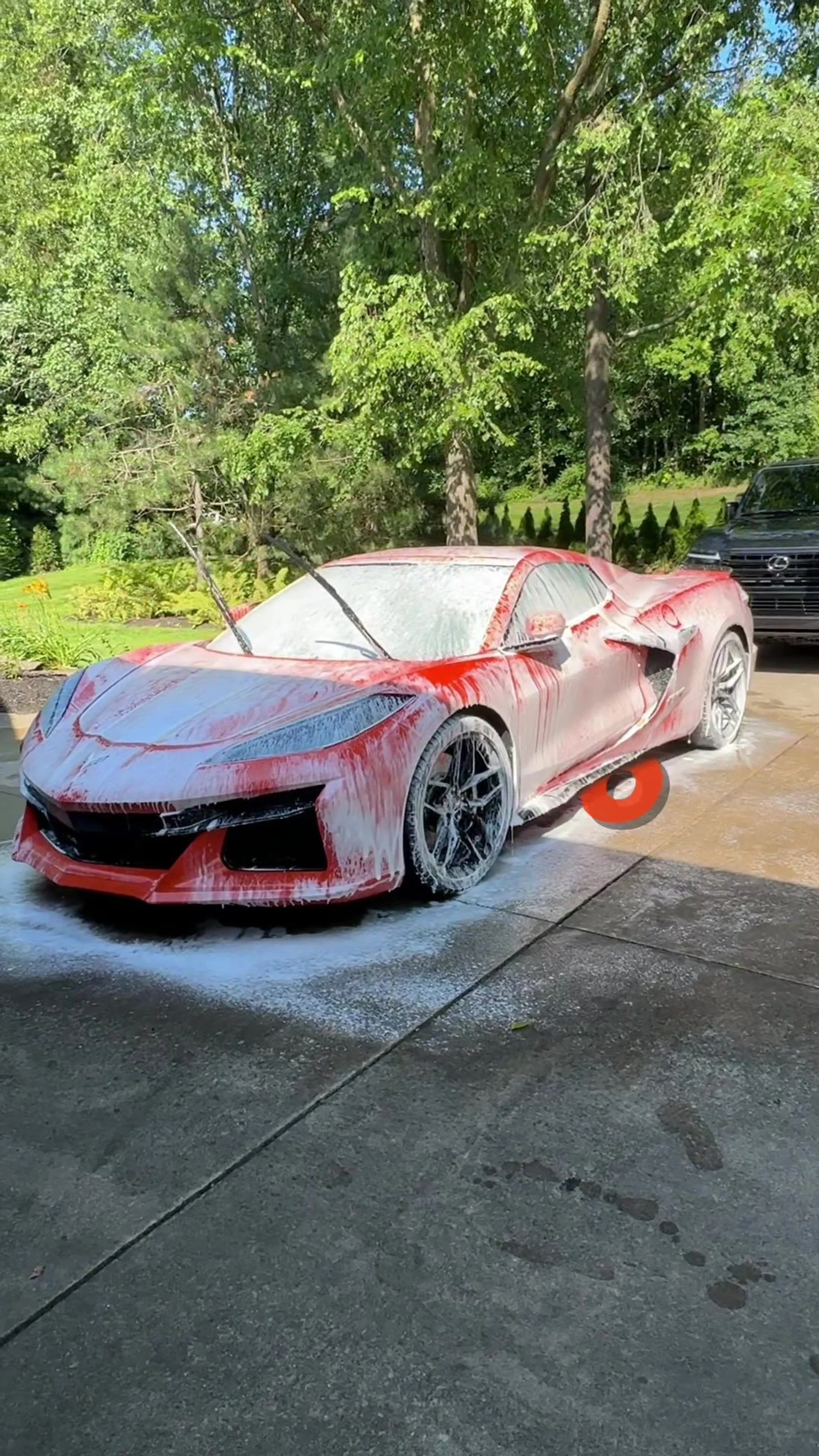 Red Corvette during a paint correction wash and decontamination