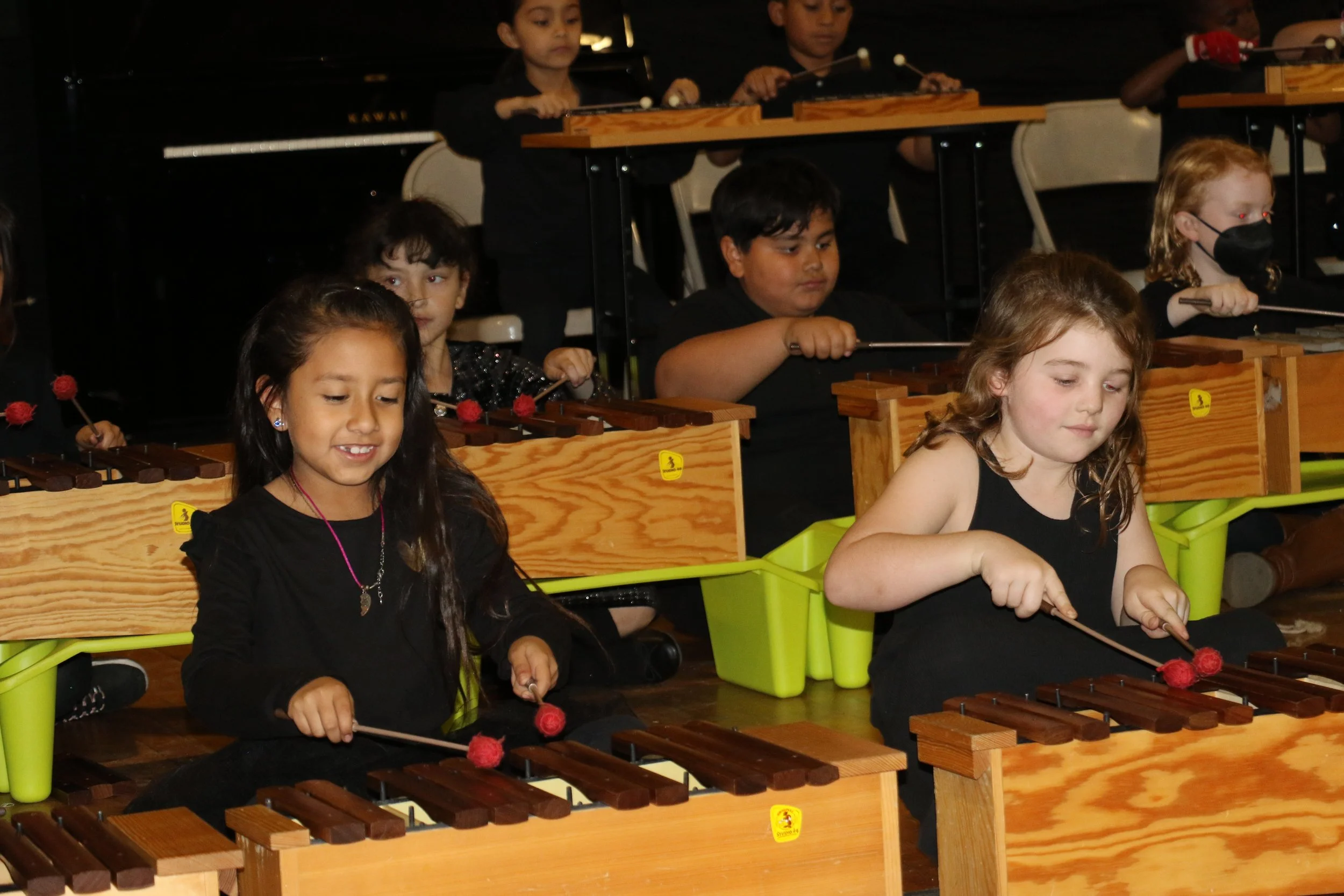 Harmony Project kindergarten students playing the xylophone during a community concert. 