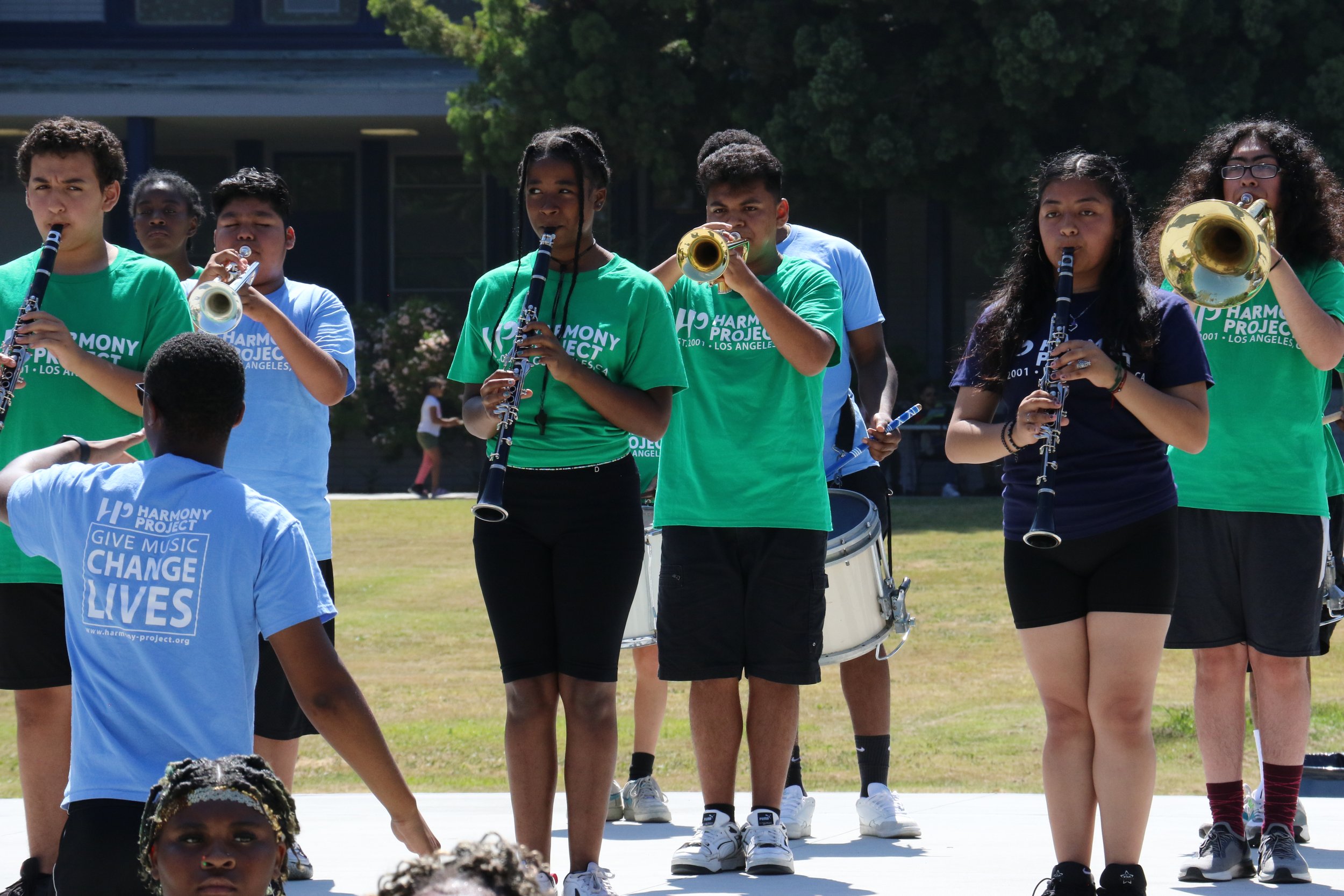 Harmony Project Precision Marching Band performing for community onlookers. 
