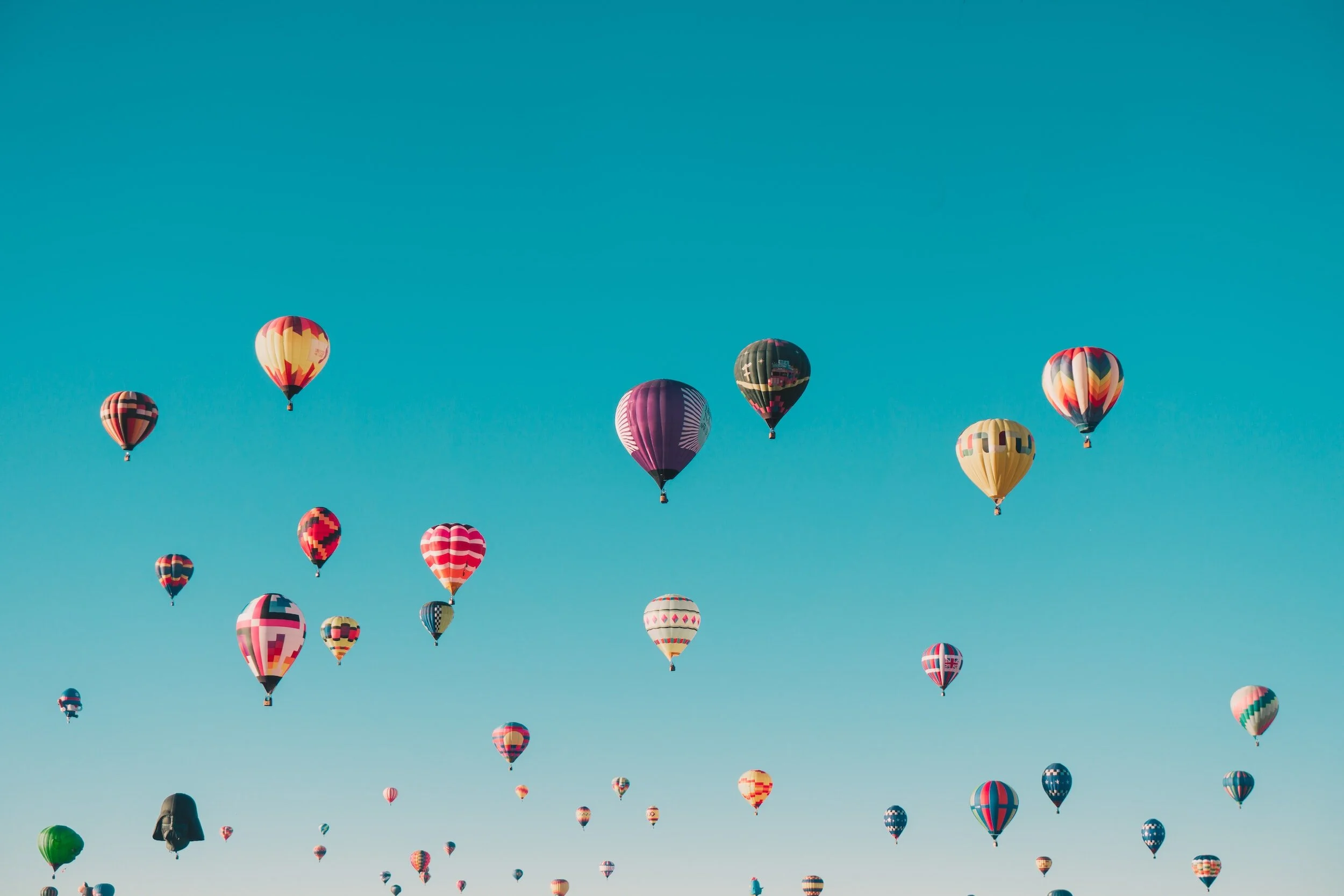 A parade of hot air balloons in the sky