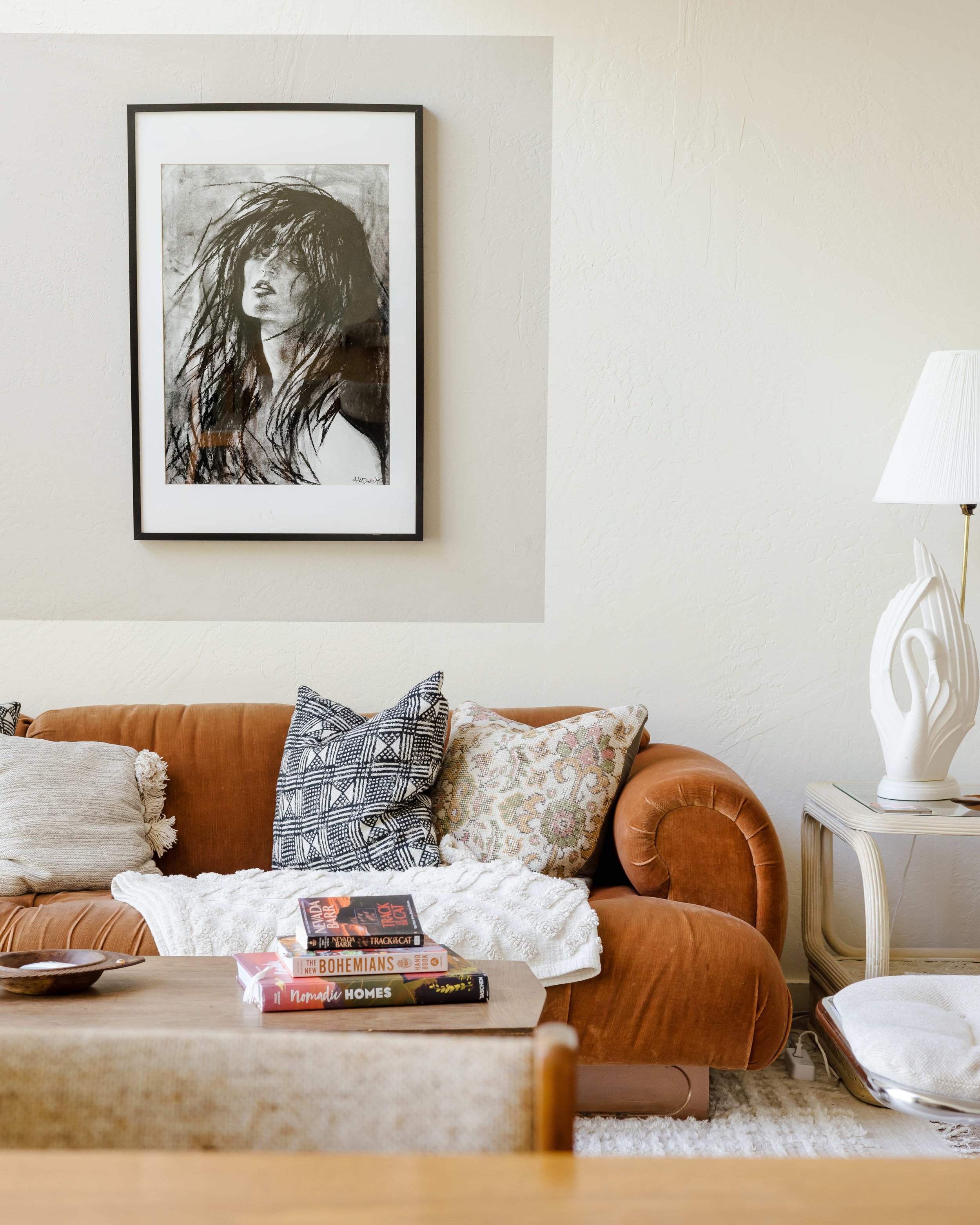 The living area features an orange velvet couch