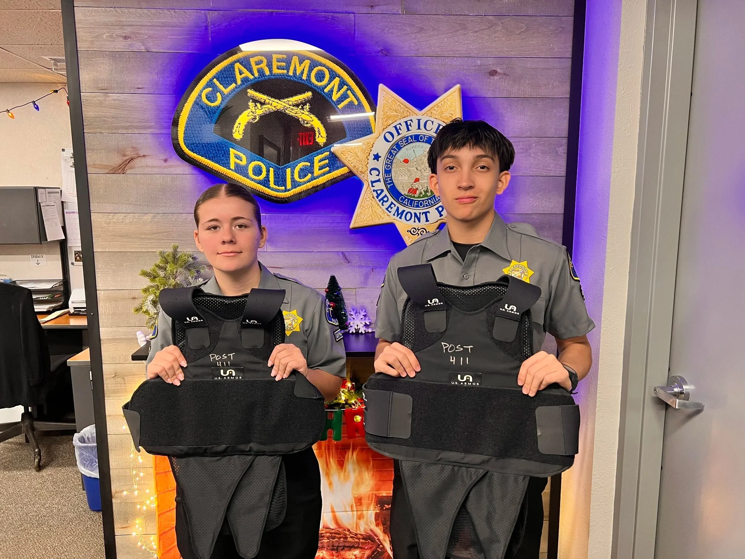 Youth holding ballistic vests donated by foundation