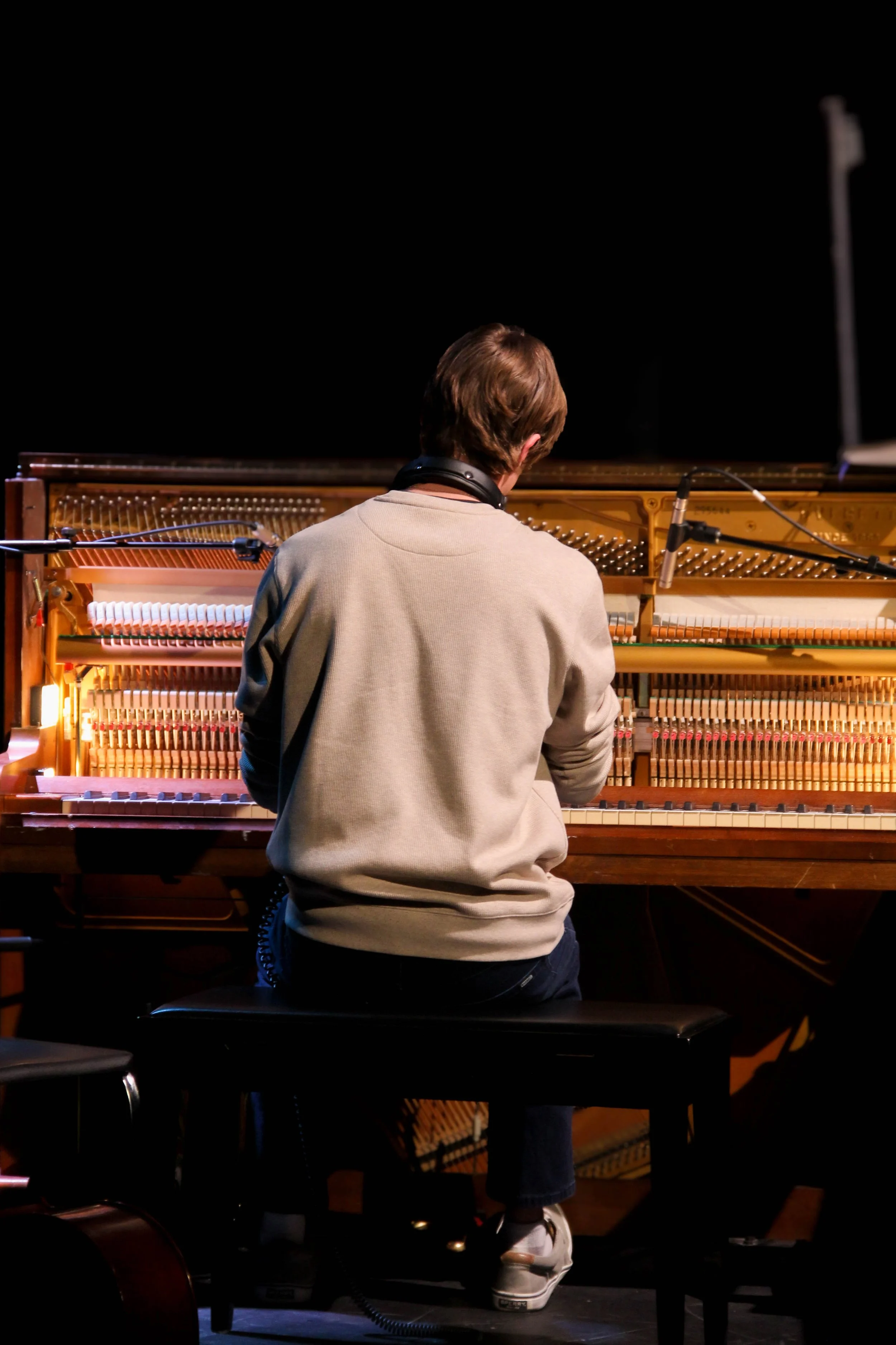 Silhouette of a person sitting outdoors during sunset with a colorful sky and clouds in the background