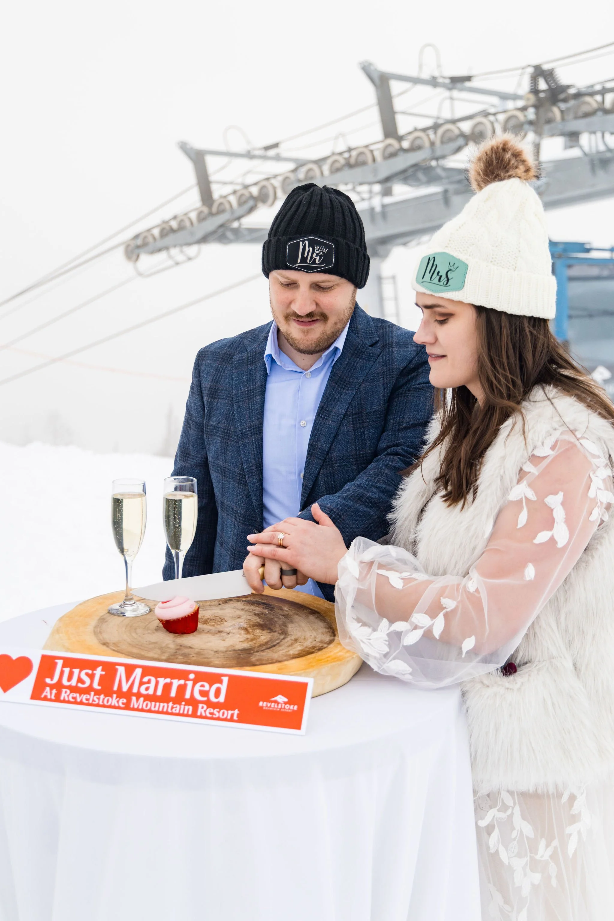 wedding couple cuts a cupcake at winter wedding