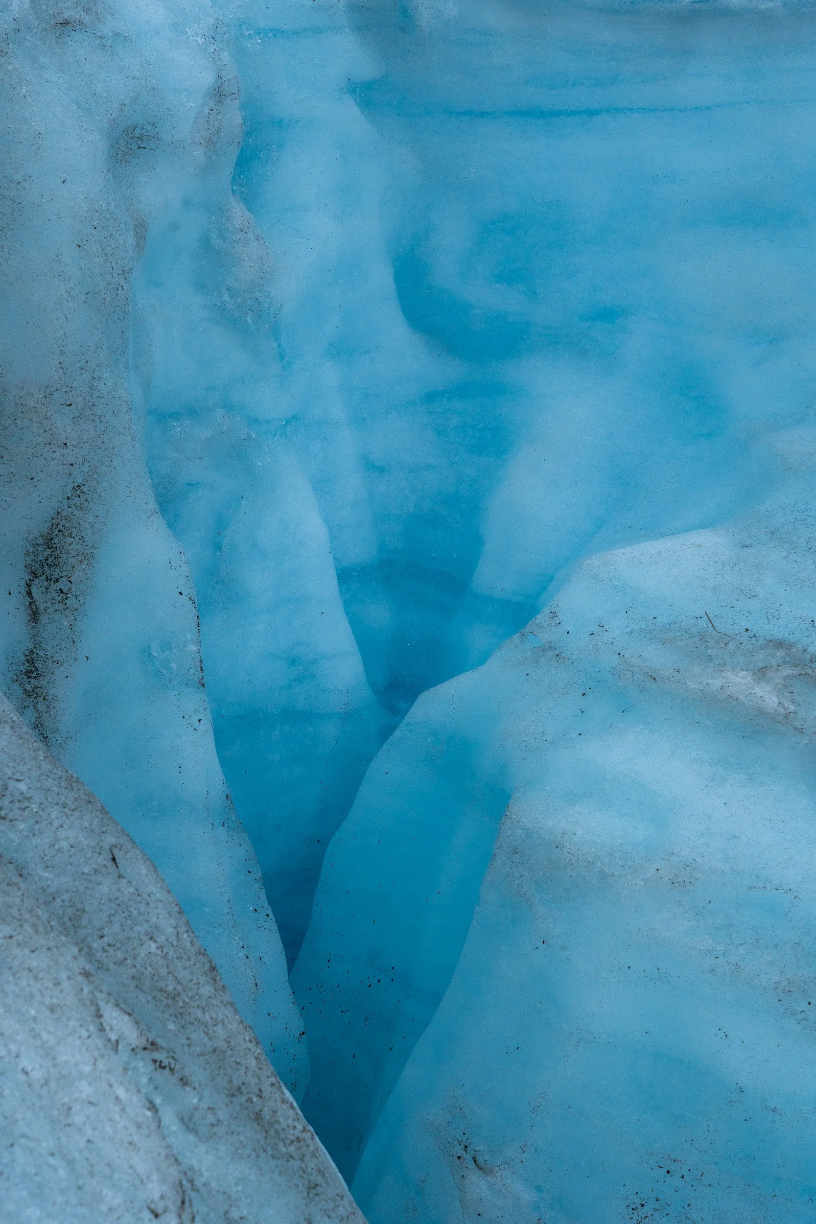 Wolverine Glacier. A moulin is formed when meltwater finds a crack in the ice and vertically erodes the ice over time. Moulins can reach the bottom of the glacier, in some case hundreds of meters deep.
