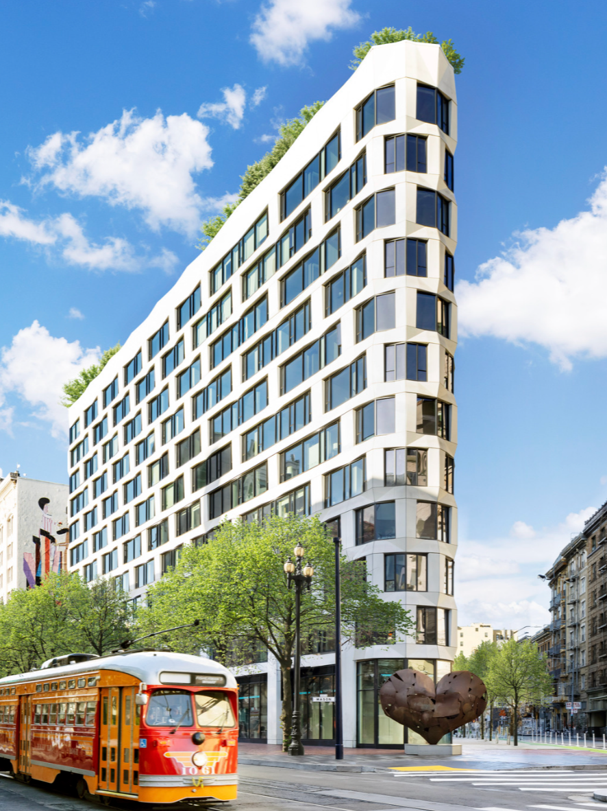 Modern white multi-story building with rounded glass windows, trees in front, and a red and yellow tram passing by on Market Street.