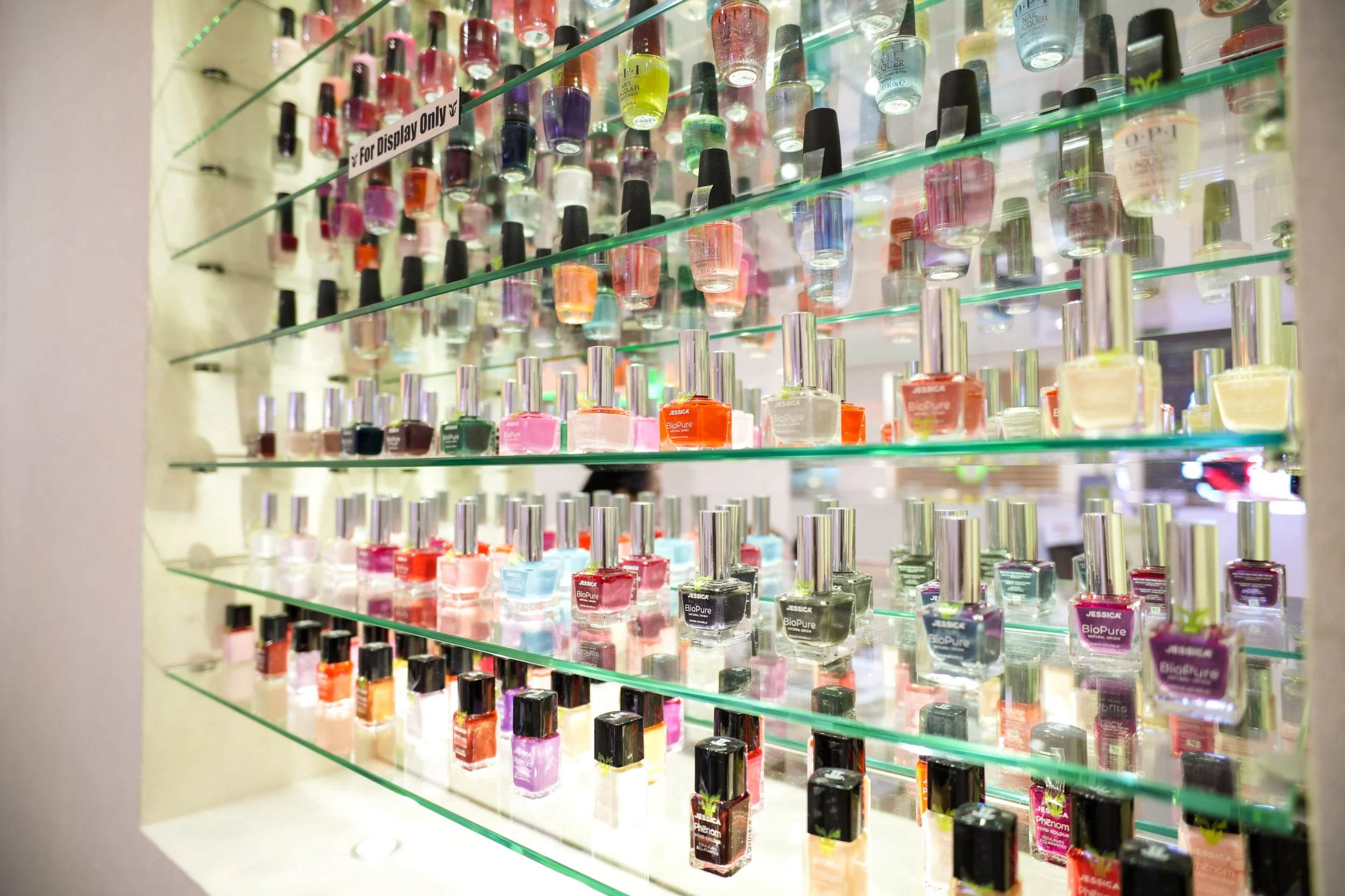 Display of colorful nail polish bottles on shelves