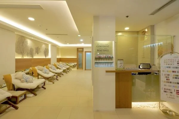 Relaxation area with cushioned lounge chairs, sea fan wall art, and soft lighting