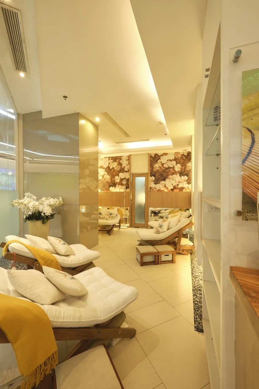 Serene spa lounge chairs with floral cushions and soft lighting