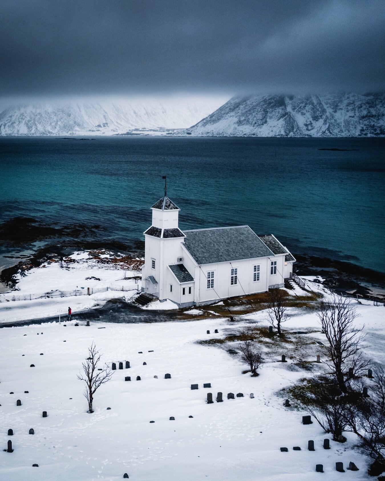 Gims&oslash;y Church is a parish church in Nordland county on the island of Gims&oslash;ya which is part of the Lofoten islands. The white wooden church was built in 1876 and with the deep blue ocean in the background and the moody mountains shrouded