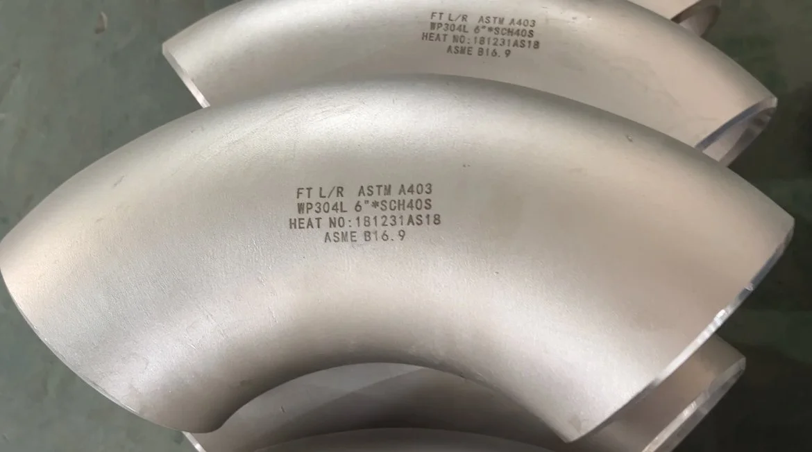 ASTM standard stainless steel elbows, marked and ready for packaging