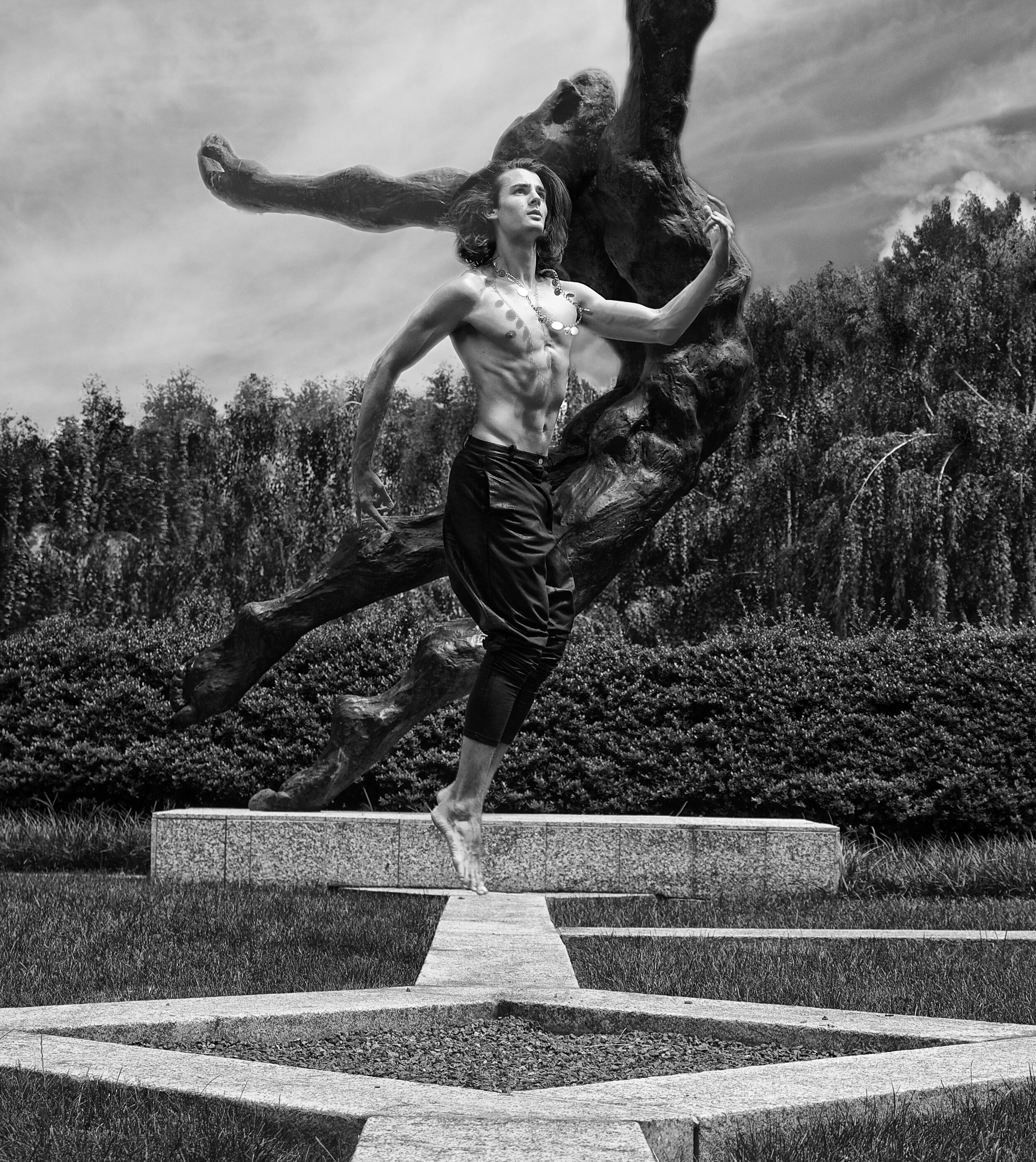 fine art print of man jumping near a statue outside