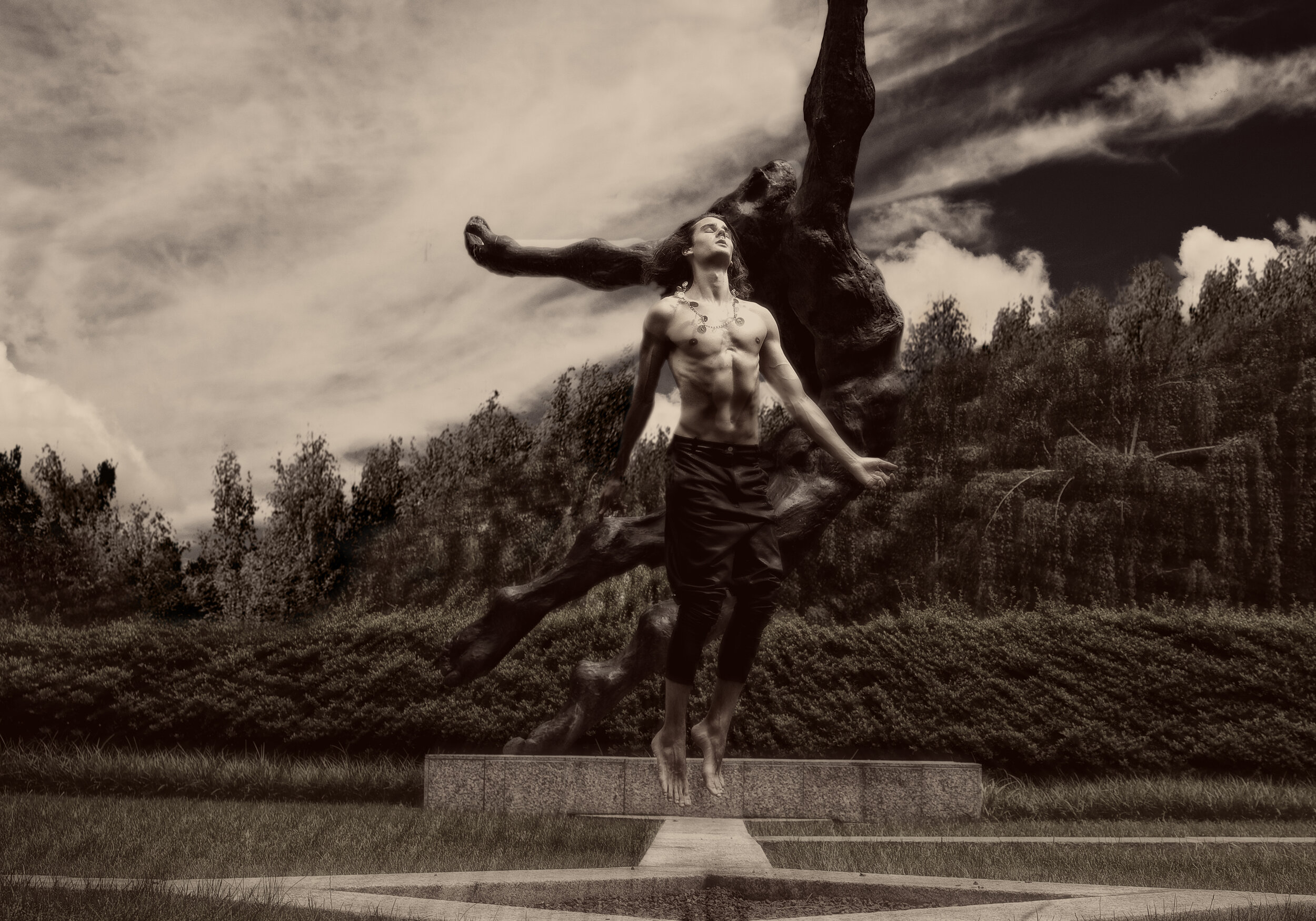 fine art print of man jumping near a statue outside