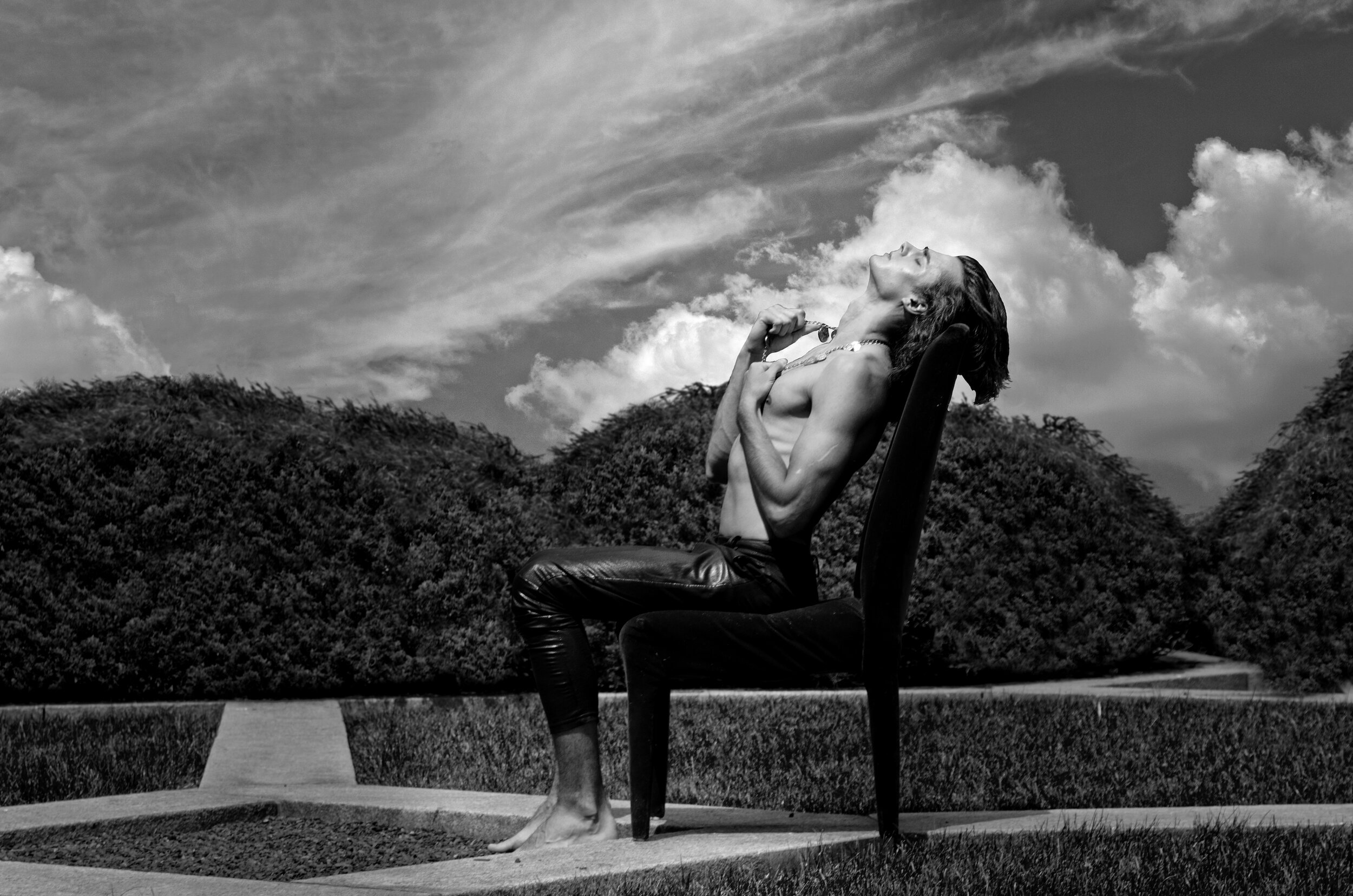 fine art print of man sitting in chair outside