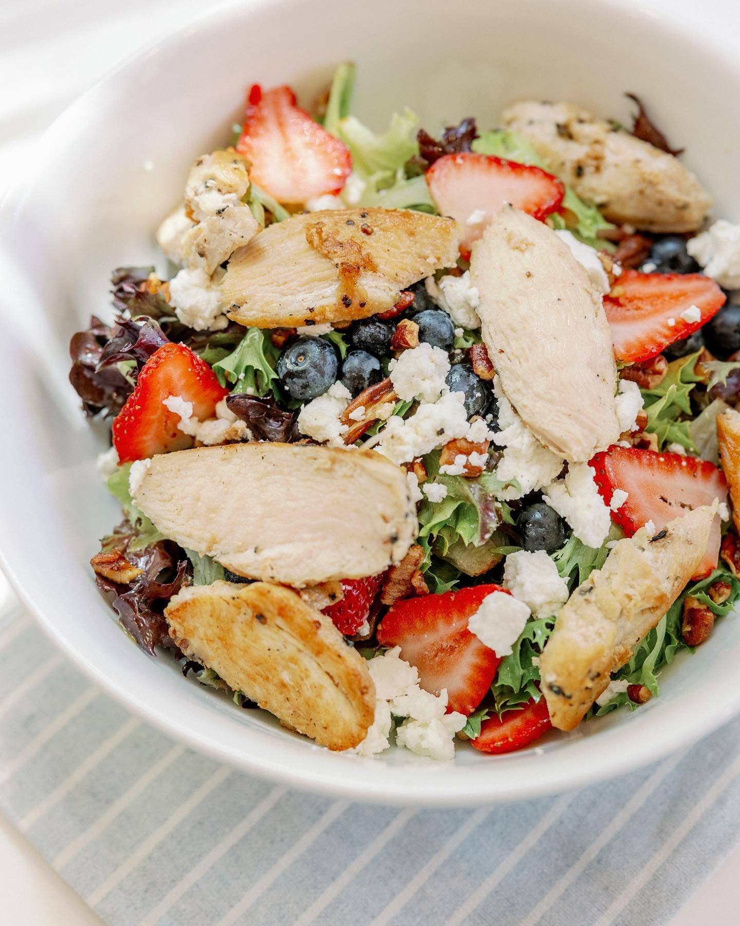 Menu spotlight! Our fresh and flavorful Berry Salad is the perfect warm weather lunch. A burst of bright colors on a bed of local green mix, this blend of strawberries, blueberries, roasted pecans and goat cheese will energize your day! Eat it as-is 