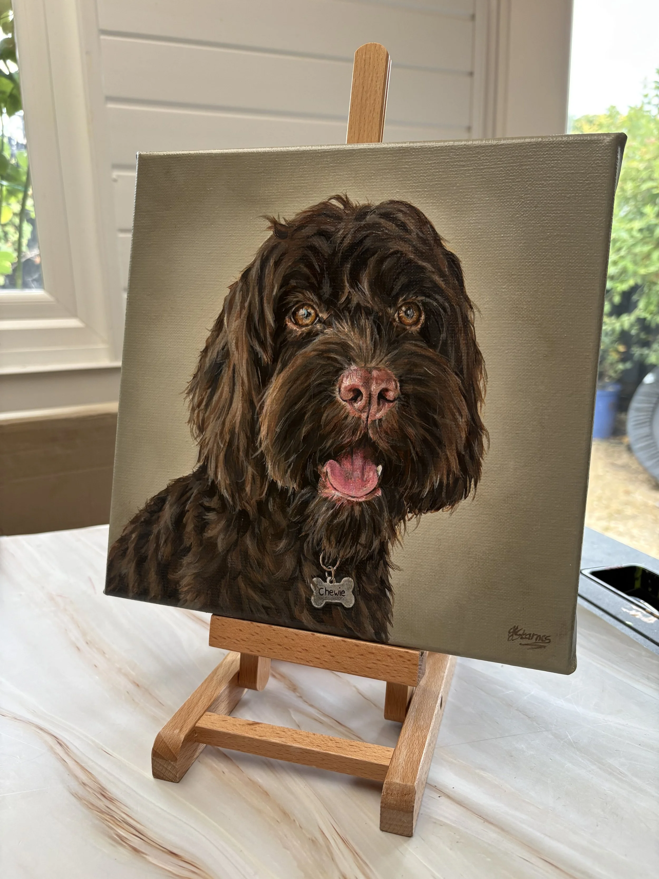 portrait painting of a chocolate brown cockapoo dog. 