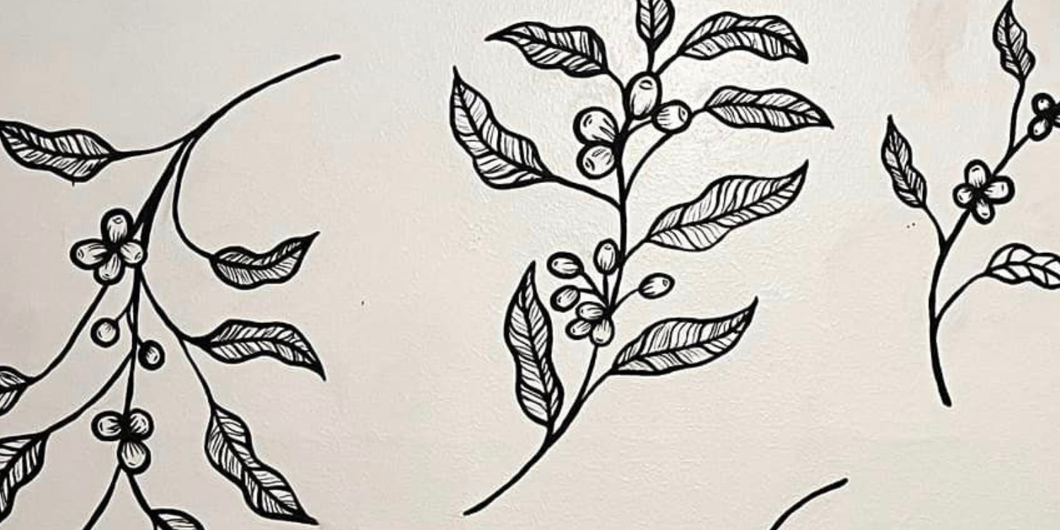 Black and white illustrated coffee plant with leaves and berries.