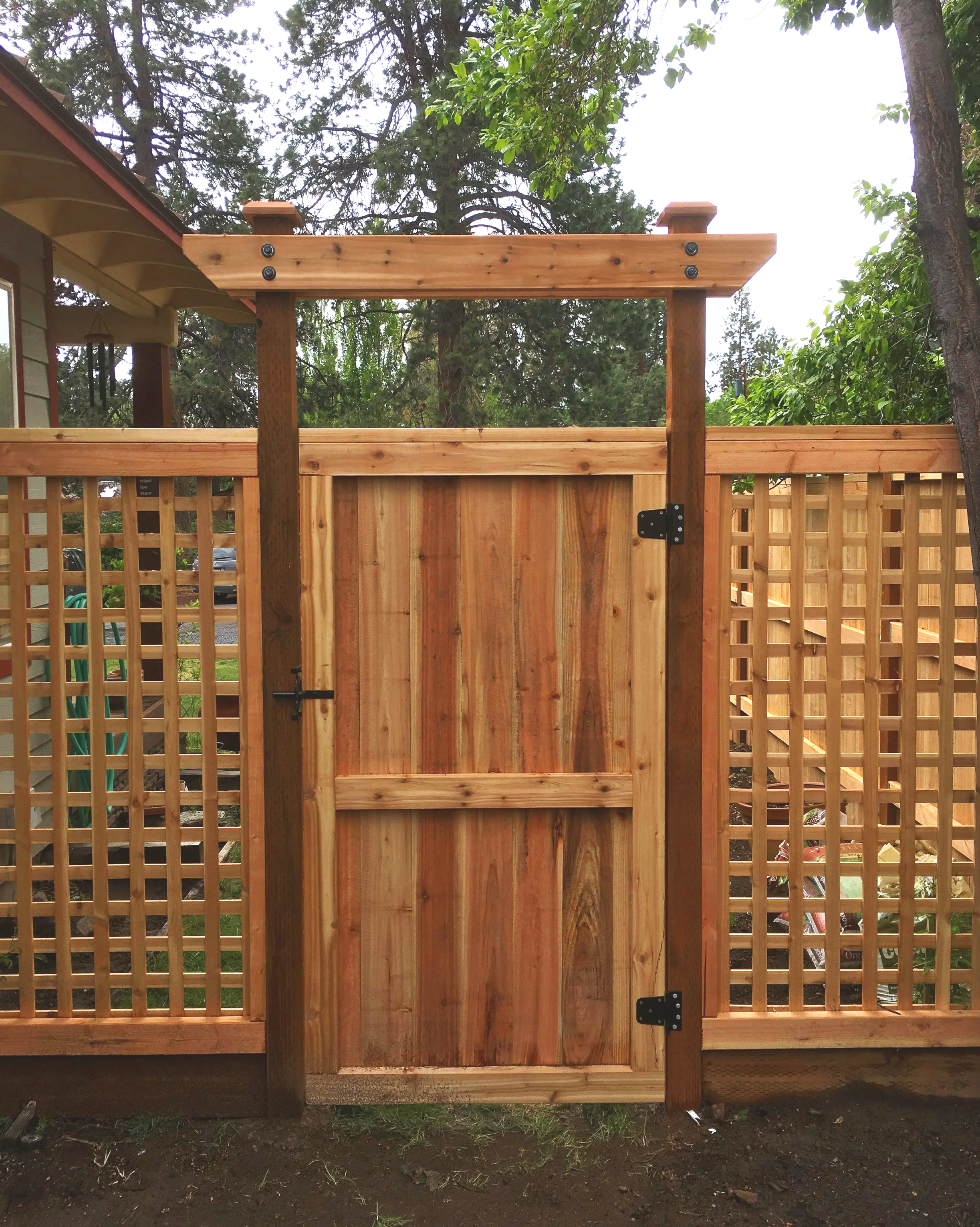 Wooden gate with lattice panels in a garden setting