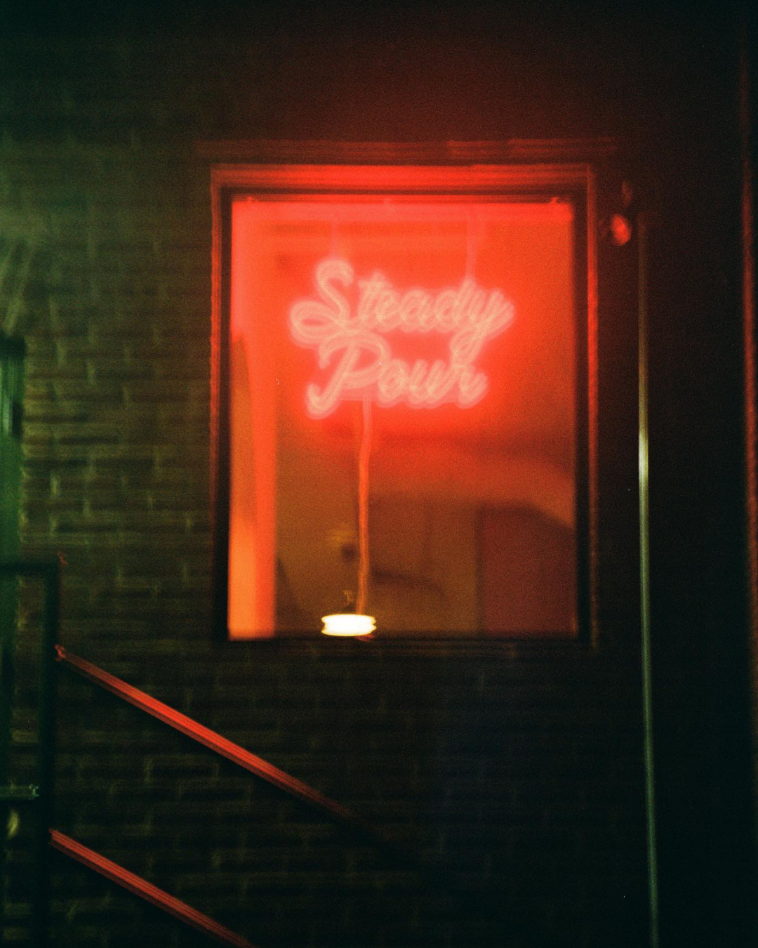 blurry photo of neon sign in window of building