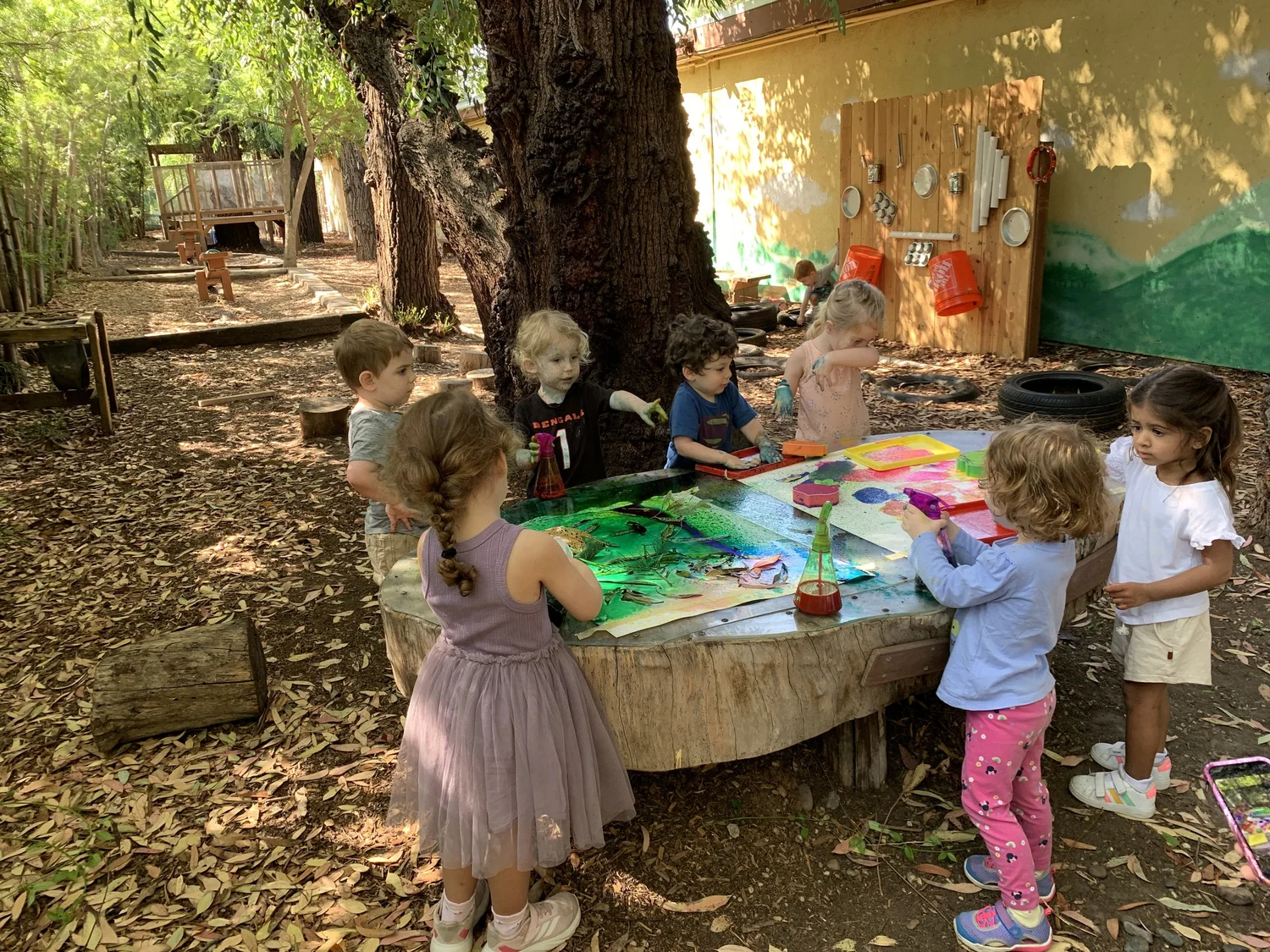 WHPS preschool children painting together outdoors