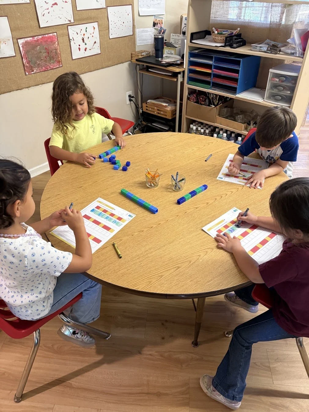 WHPS Early TK children exploring mathematics with linking cubes