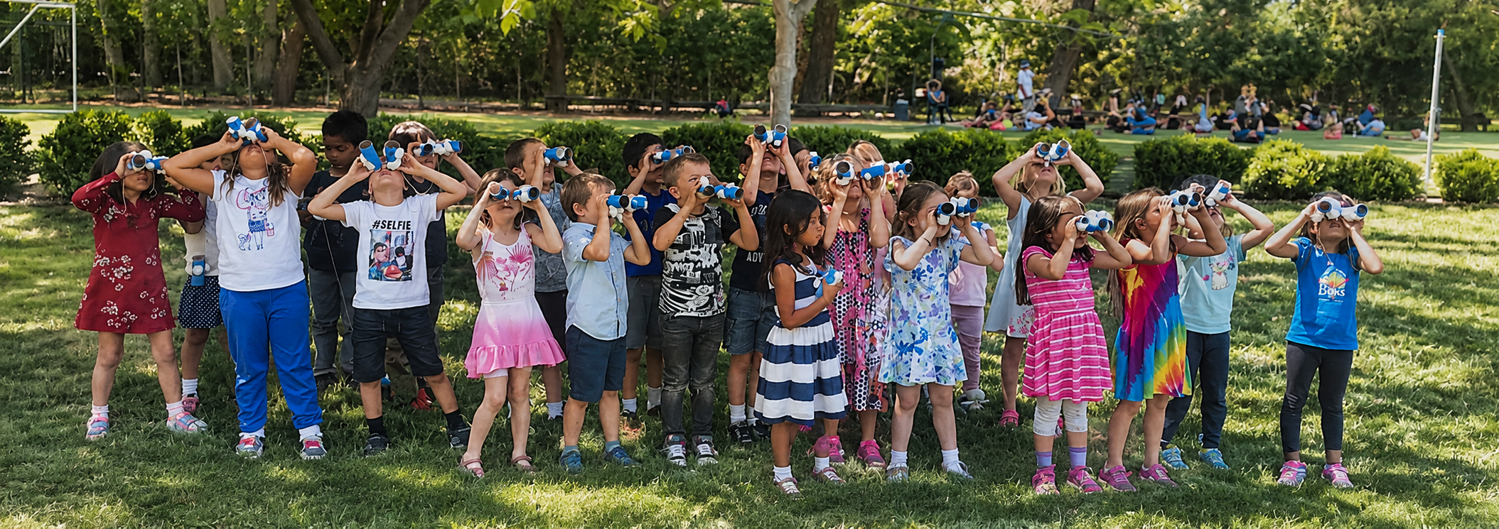 WHPS students exploring outdoors with binoculars