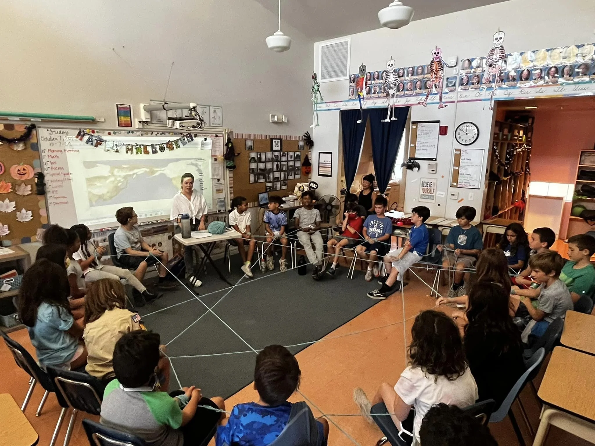 Upper Elementary students participating in a classroom discussion about immigration