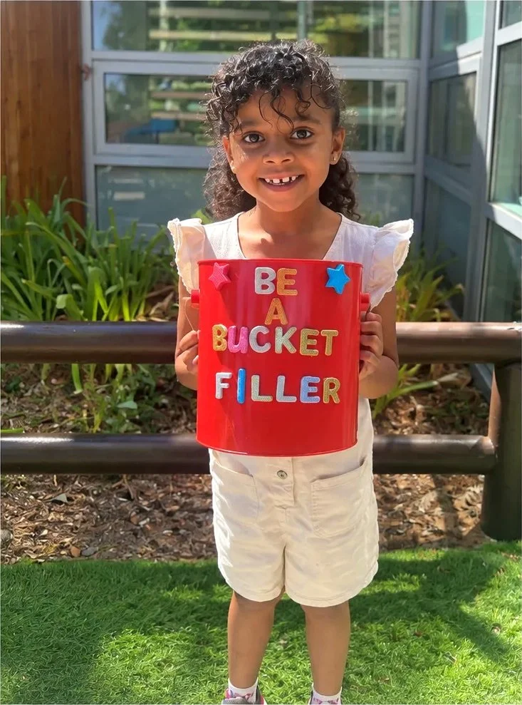 WHPS student holding a Be a Bucket Filler bucket