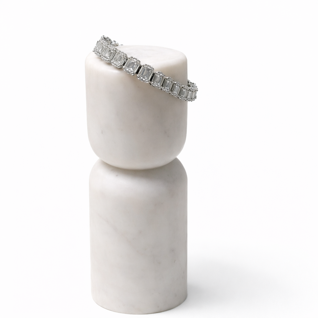 Elegant diamond bracelet on marble pedestals.png