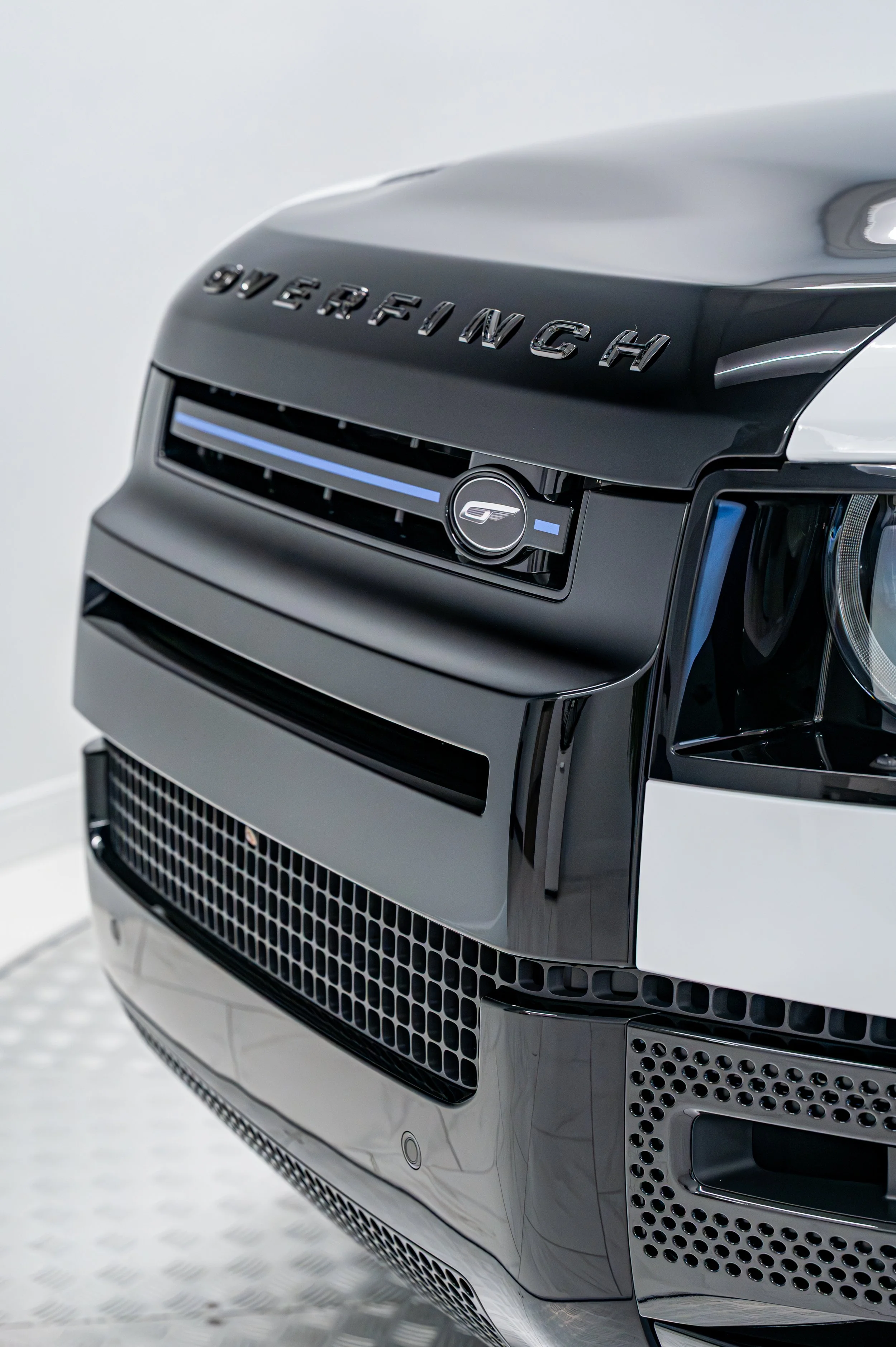 Automotive detail photo of a high-end SUV grille in a studio setting.