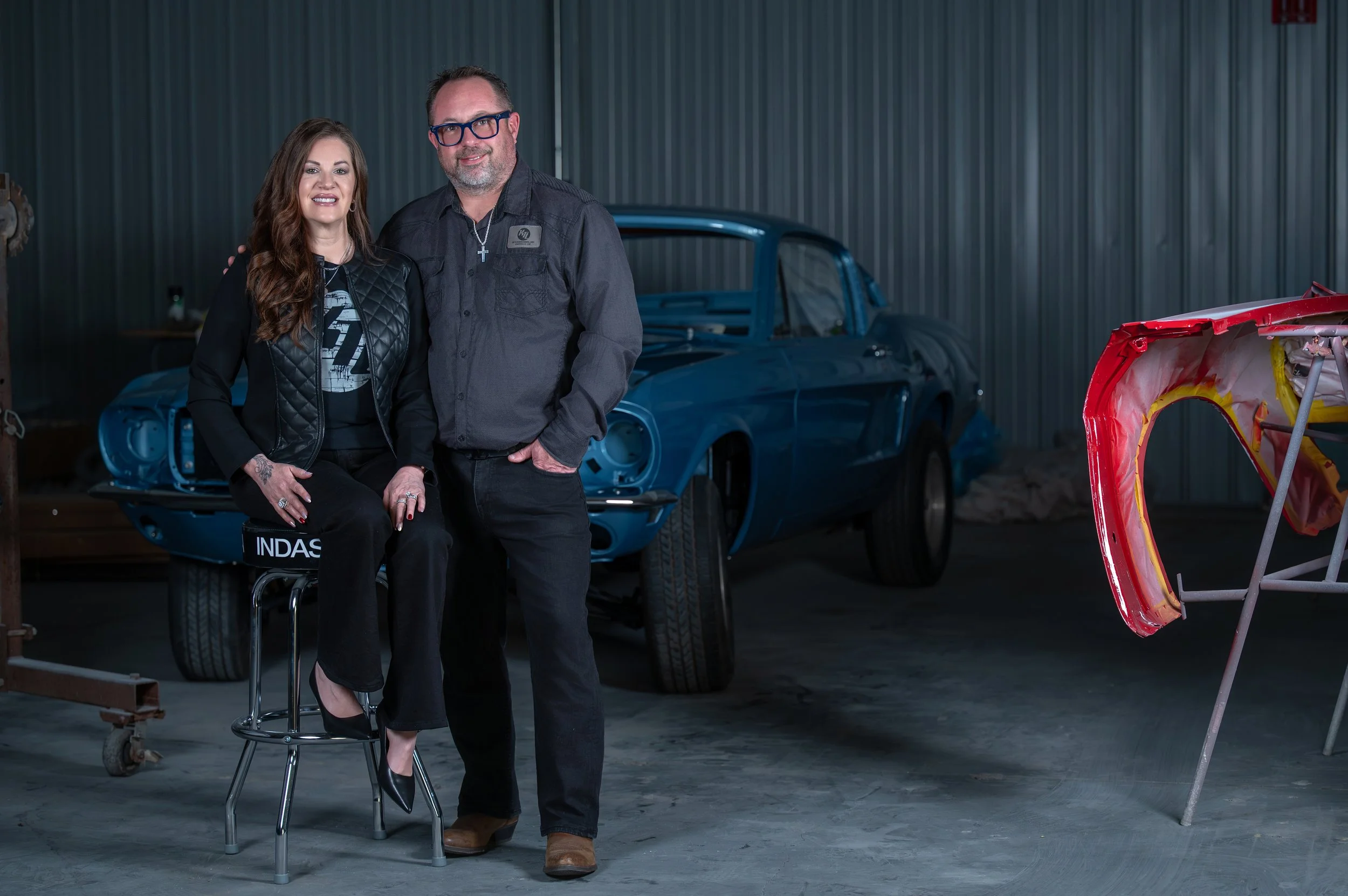 A man and woman standing inside a garage professional headshot danville, va