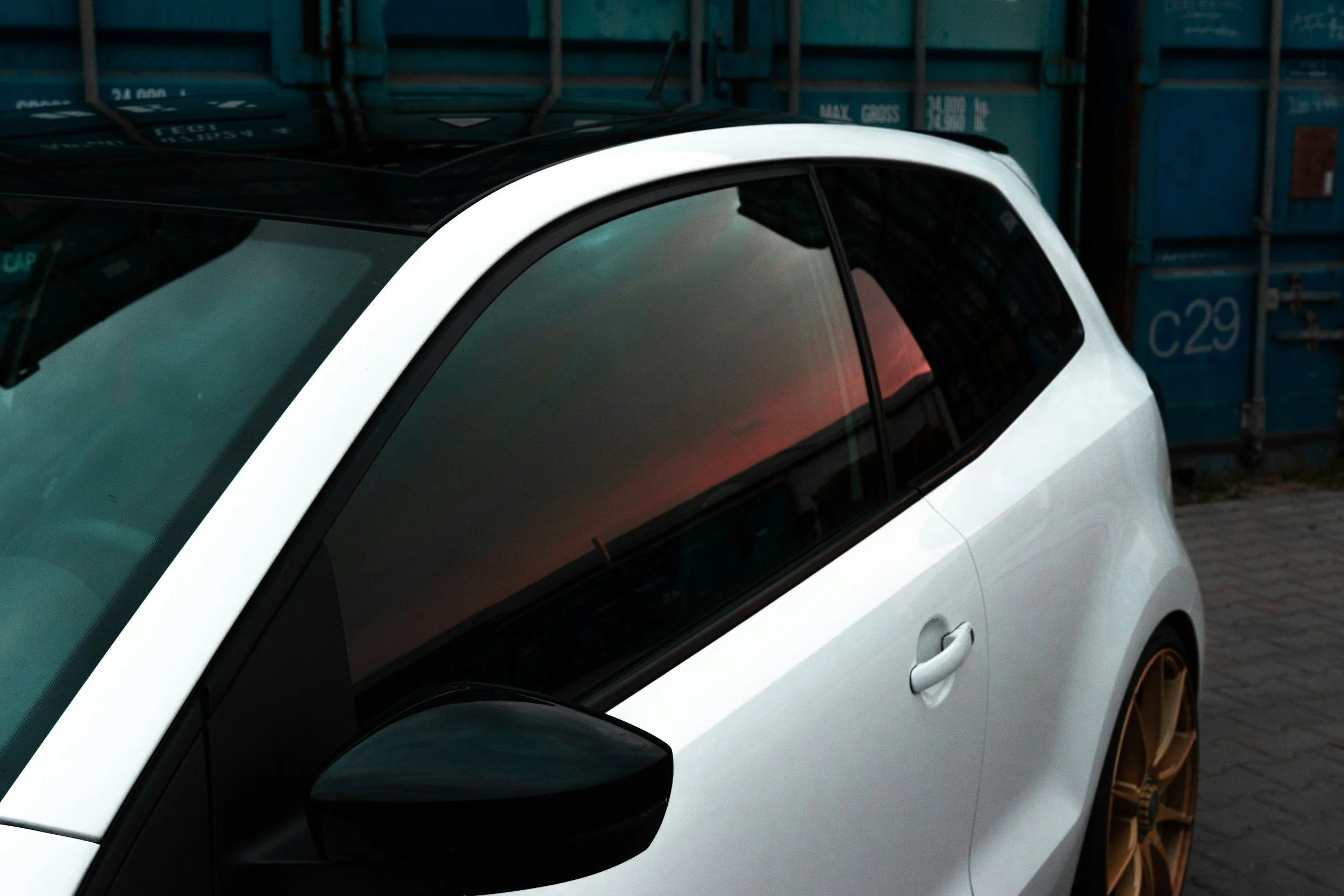 A white car with dark window tint