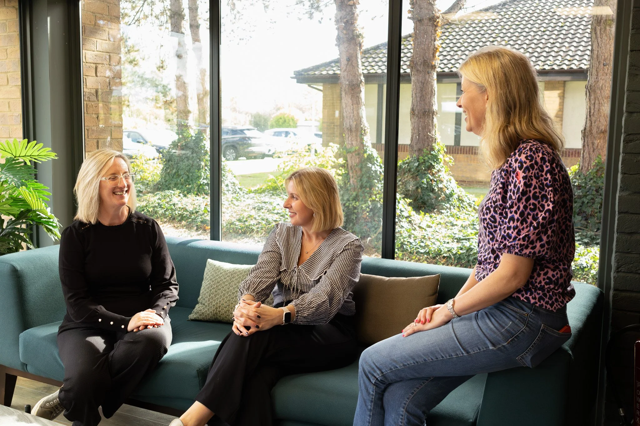 business women discussing around a sofa